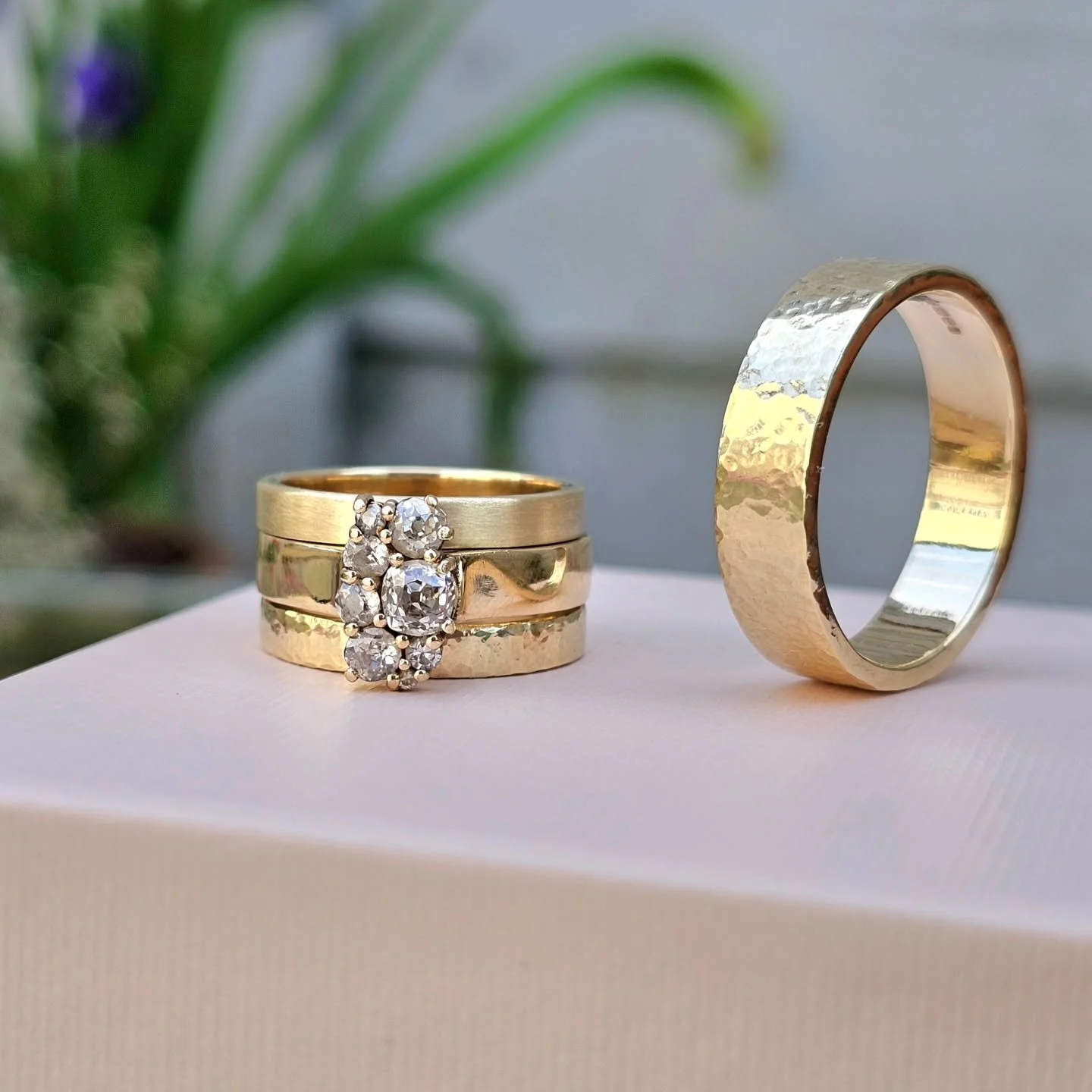 This will be an everlasting love!!! Would you look at that stack?! Bold, stylish and unique, yet still maintaining elegance. I love how the groom has gone for a matching hammered gold band too. This couple sure has style. 

They are all made entirely