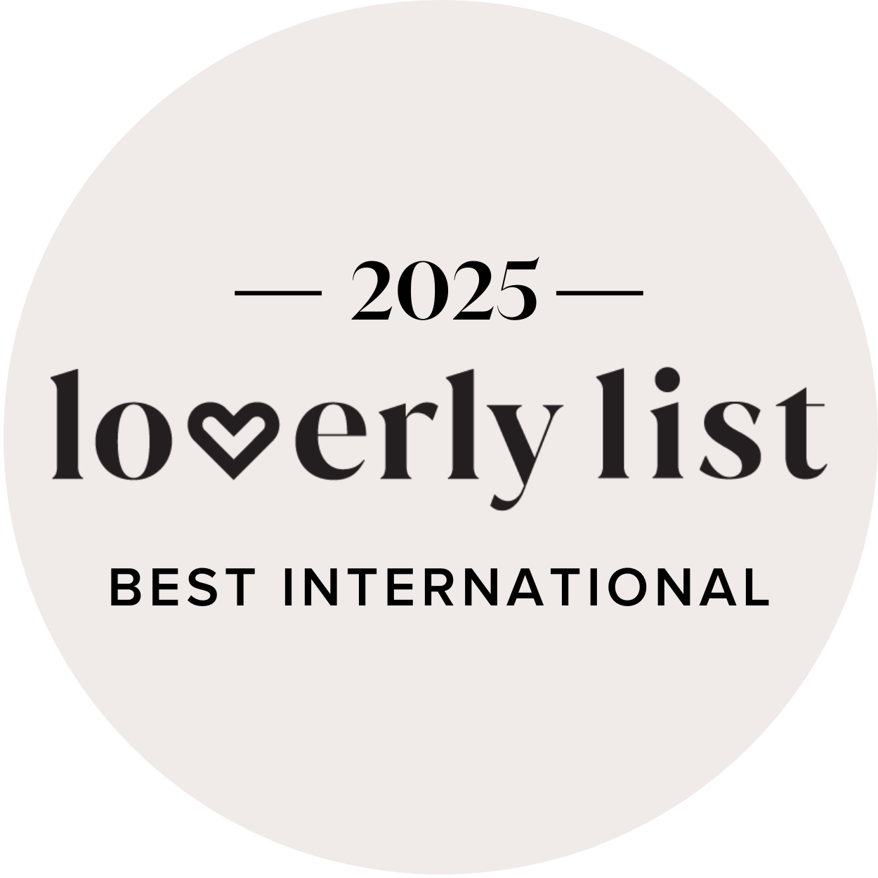A circular badge with a black border and a light gray background that reads "2025 Loverly List Best International".