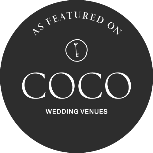 Logo with text saying "As Featured on COCO Wedding Venues" and a small key icon inside a circle.