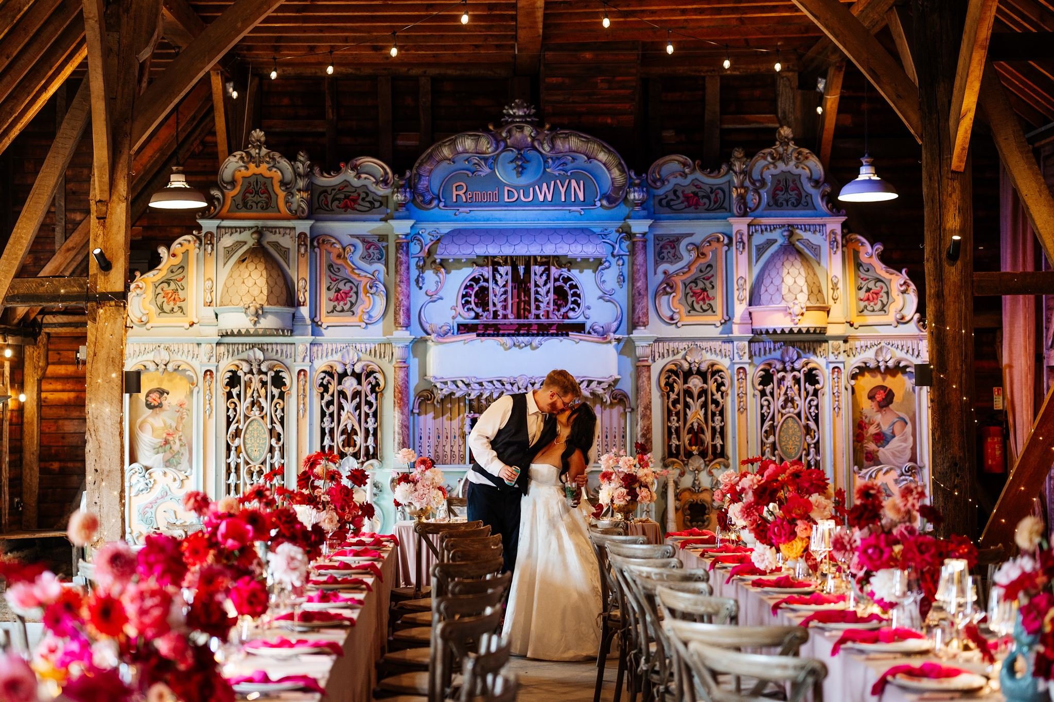 Diana and Sean surrounded by colourful wedding flowers and styled reception tables at Preston Court