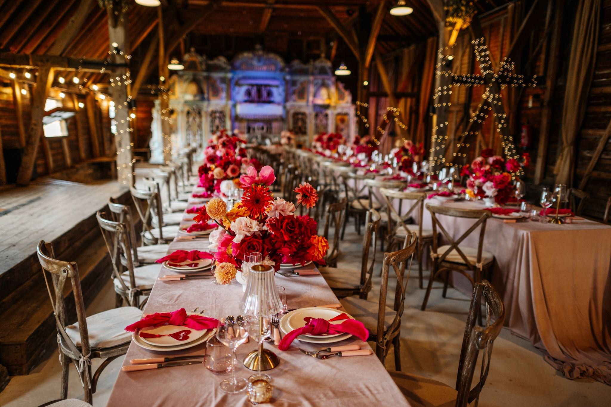 Preston Court barn wedding reception with colourful floral centrepieces and pink table details