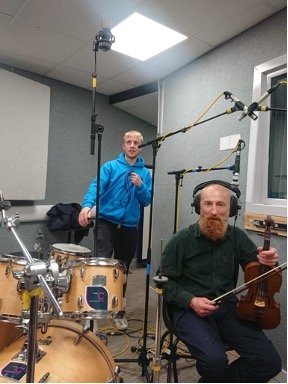 studio recording engineer setting up microphone