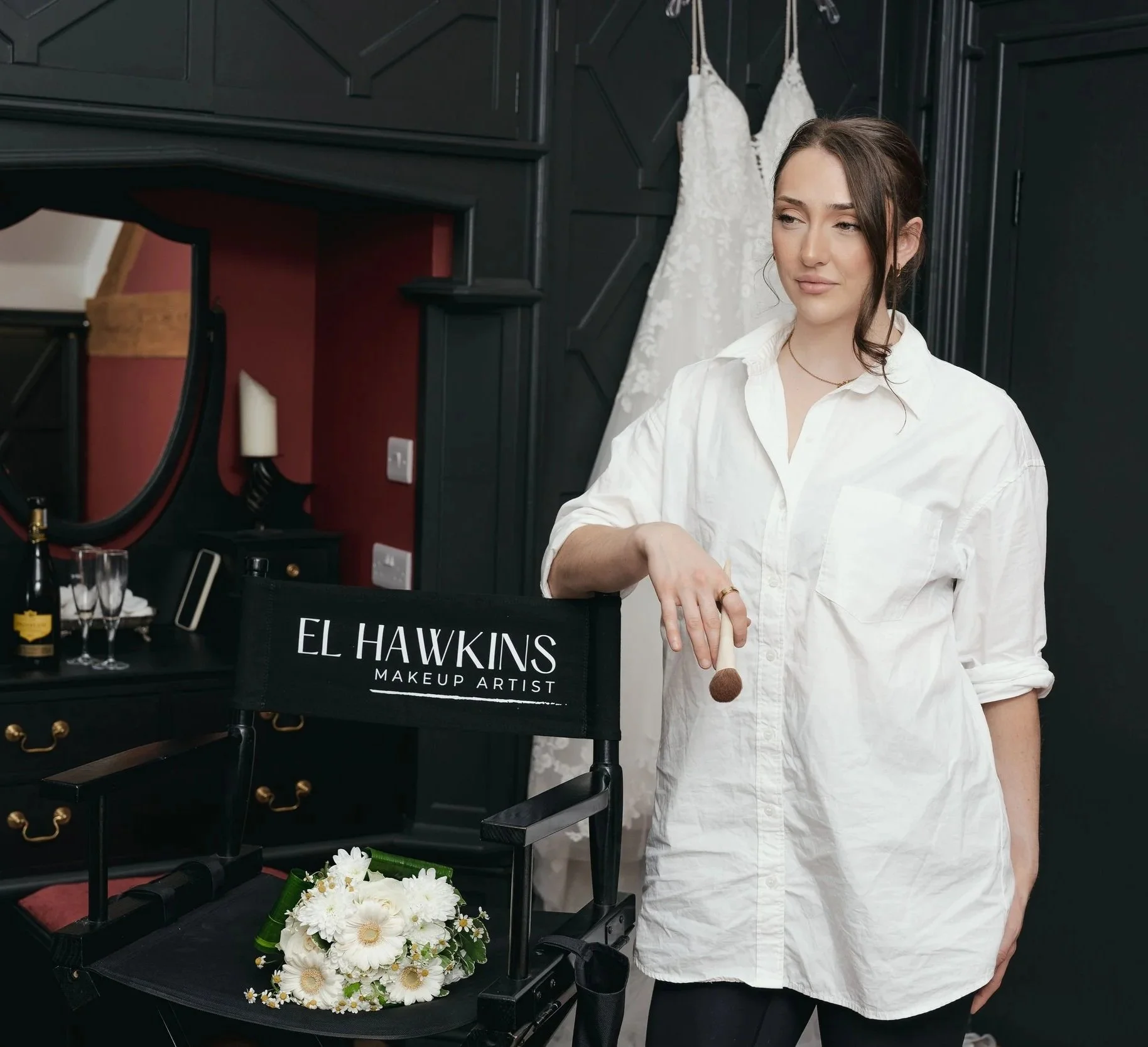 Makeupbyelhawkins a west midlands bridal makep artist holding a makeup brush leaning against a makeup chair