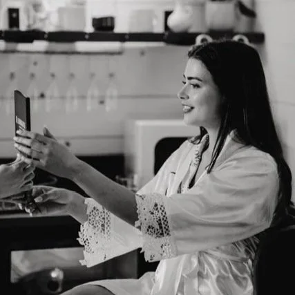 bride holding mirror seeing bridal makeup, Solihull bridal makeup artist, Birmingham  bridal makeup artist west midlands bridal makeup for the first time