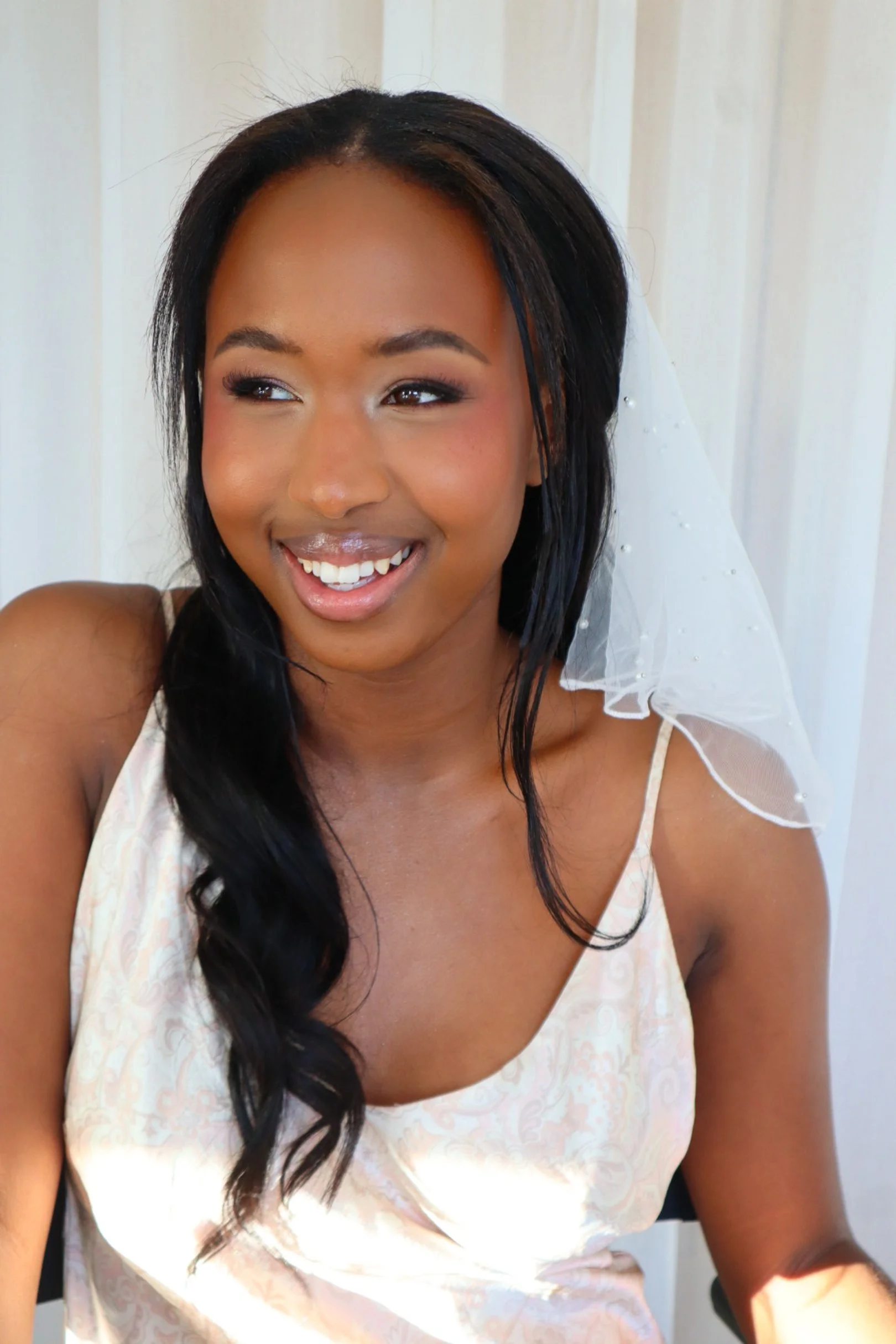 Deeper skin toned women wearing bridal makeup 