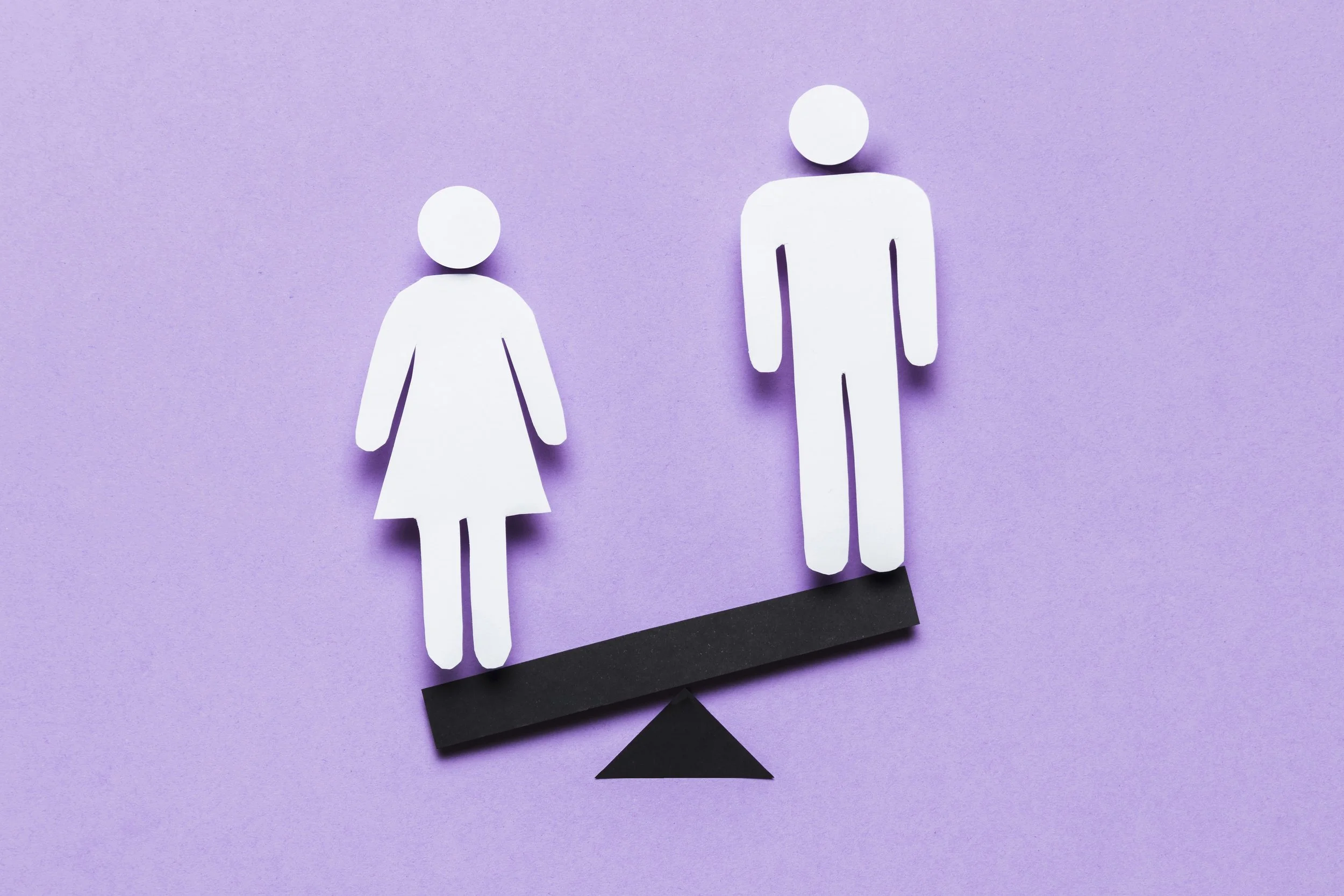 Paper cutouts of a woman and a man on a purple background, balanced on a seesaw.