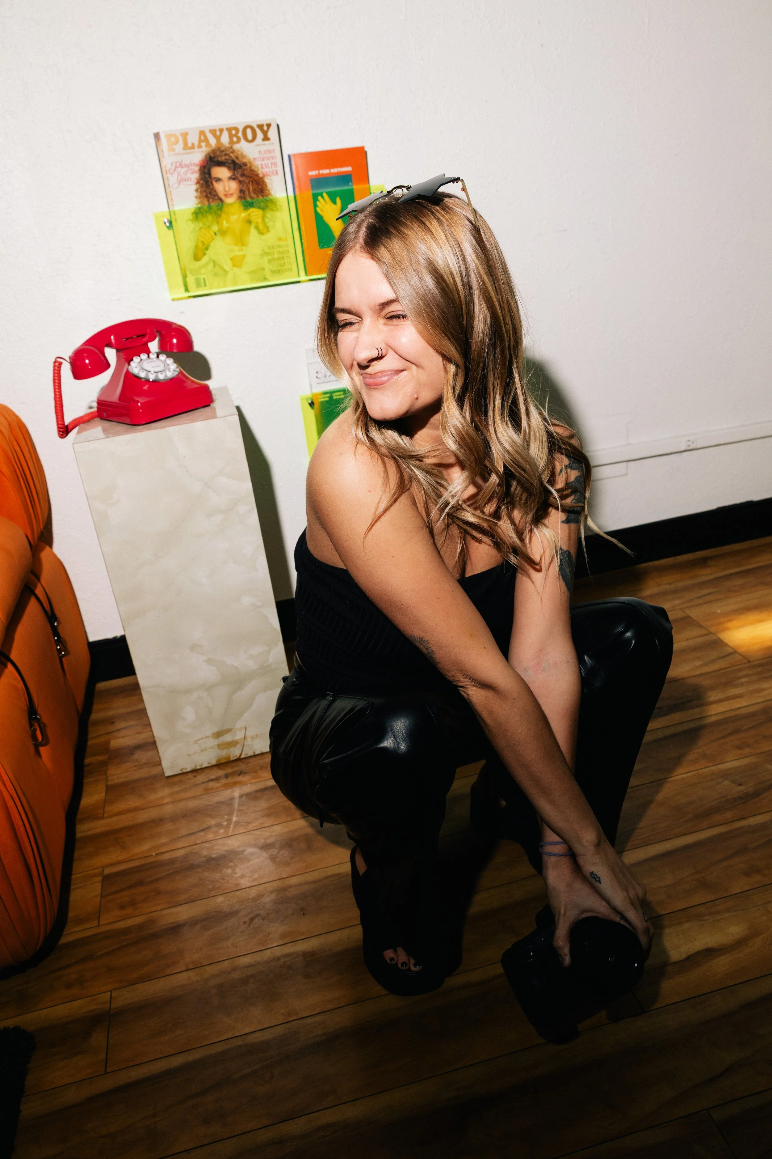 photographer posing in front of playboy magazine