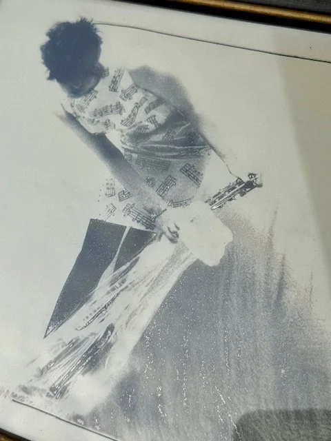 Close-up of abstract figure in motion with musical motifs, expressive black and white composition with soft gradients