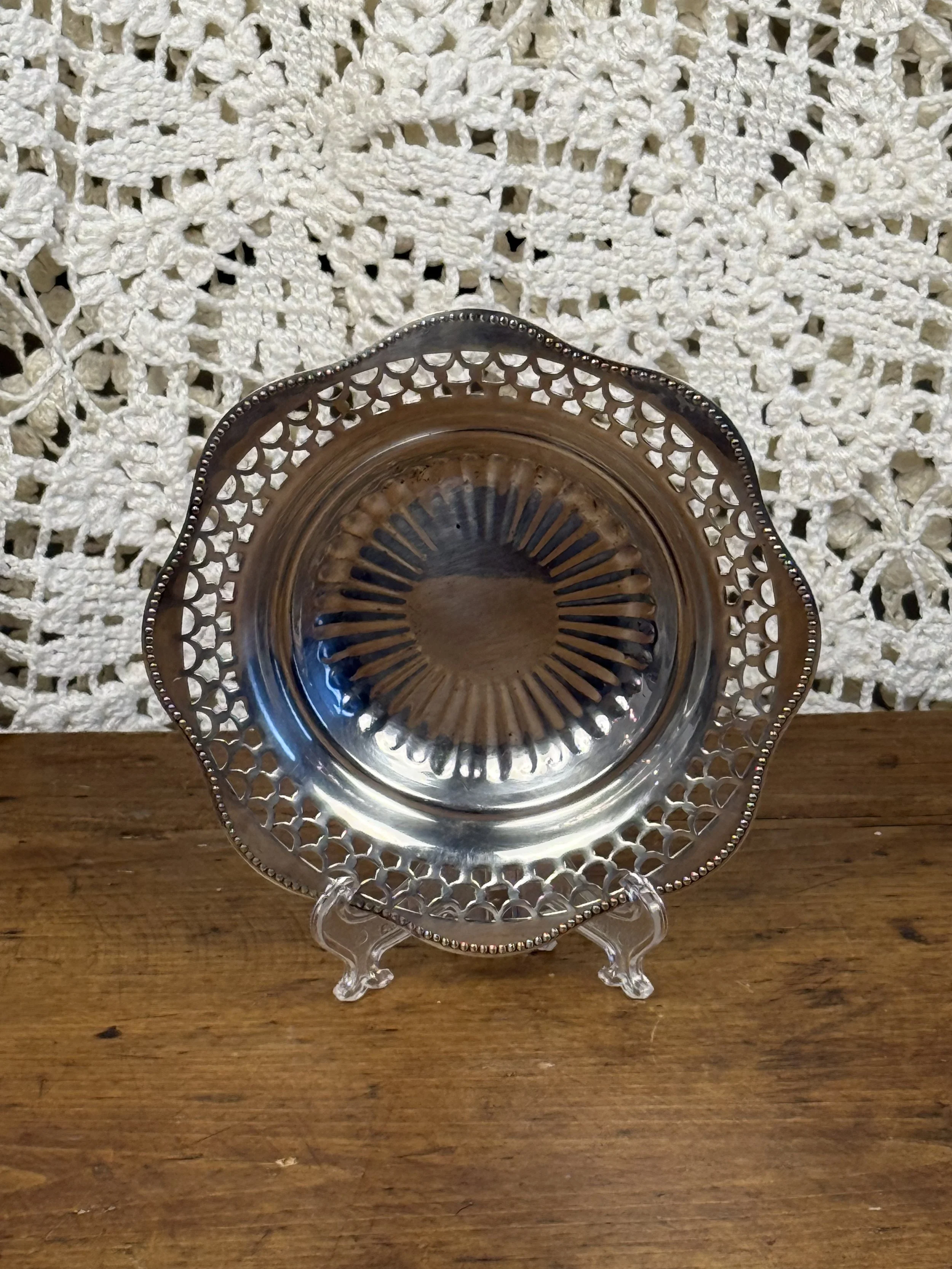Vintage EP Copper Viking Plate silverplate serving dish displayed on stand, pierced border and reflective sunburst center