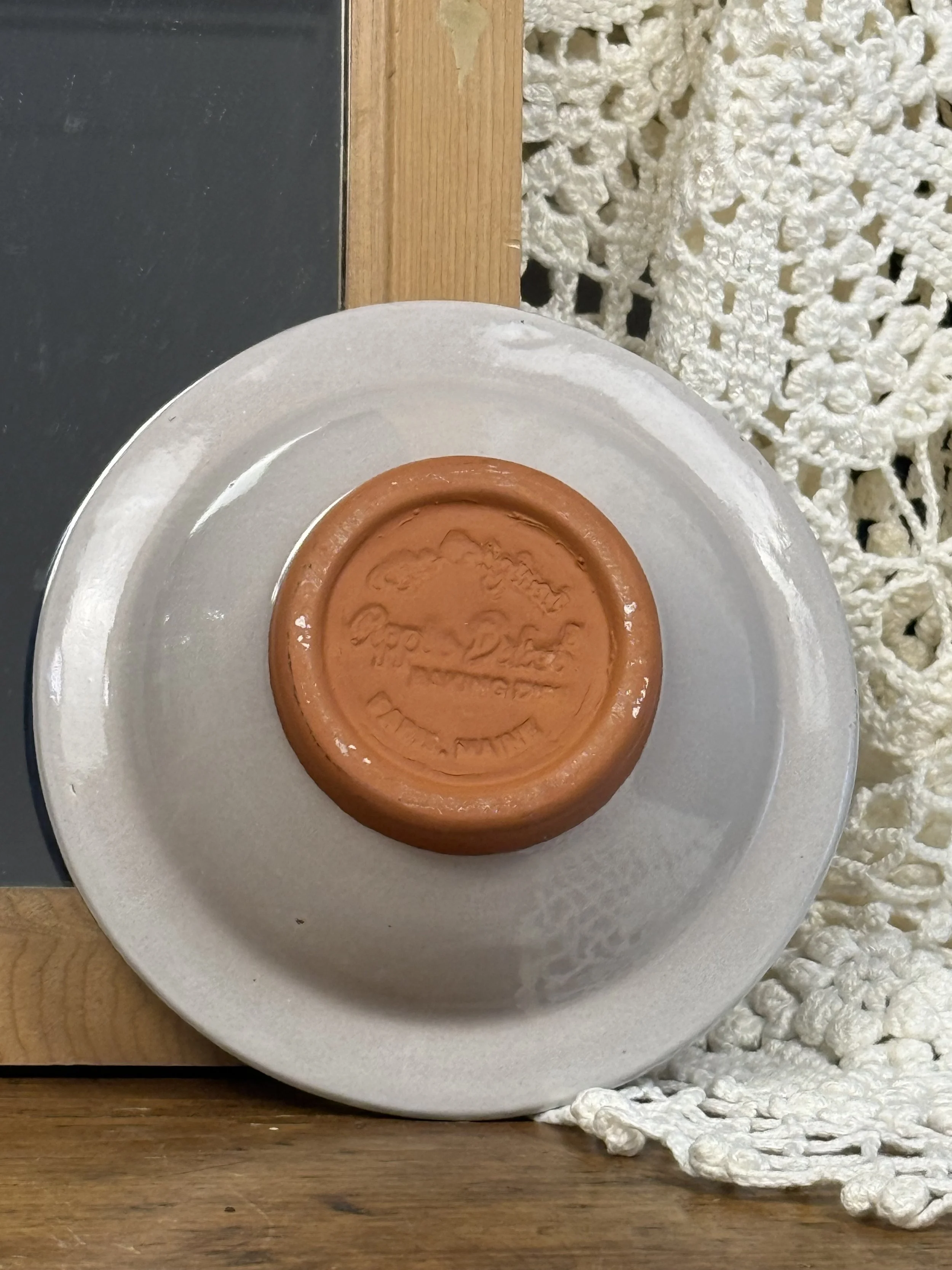 Vintage terracotta apple baker styled on wooden surface, rustic Americana glazed earthenware baking dish with center chimney, Paris Maine USA studio utility pottery