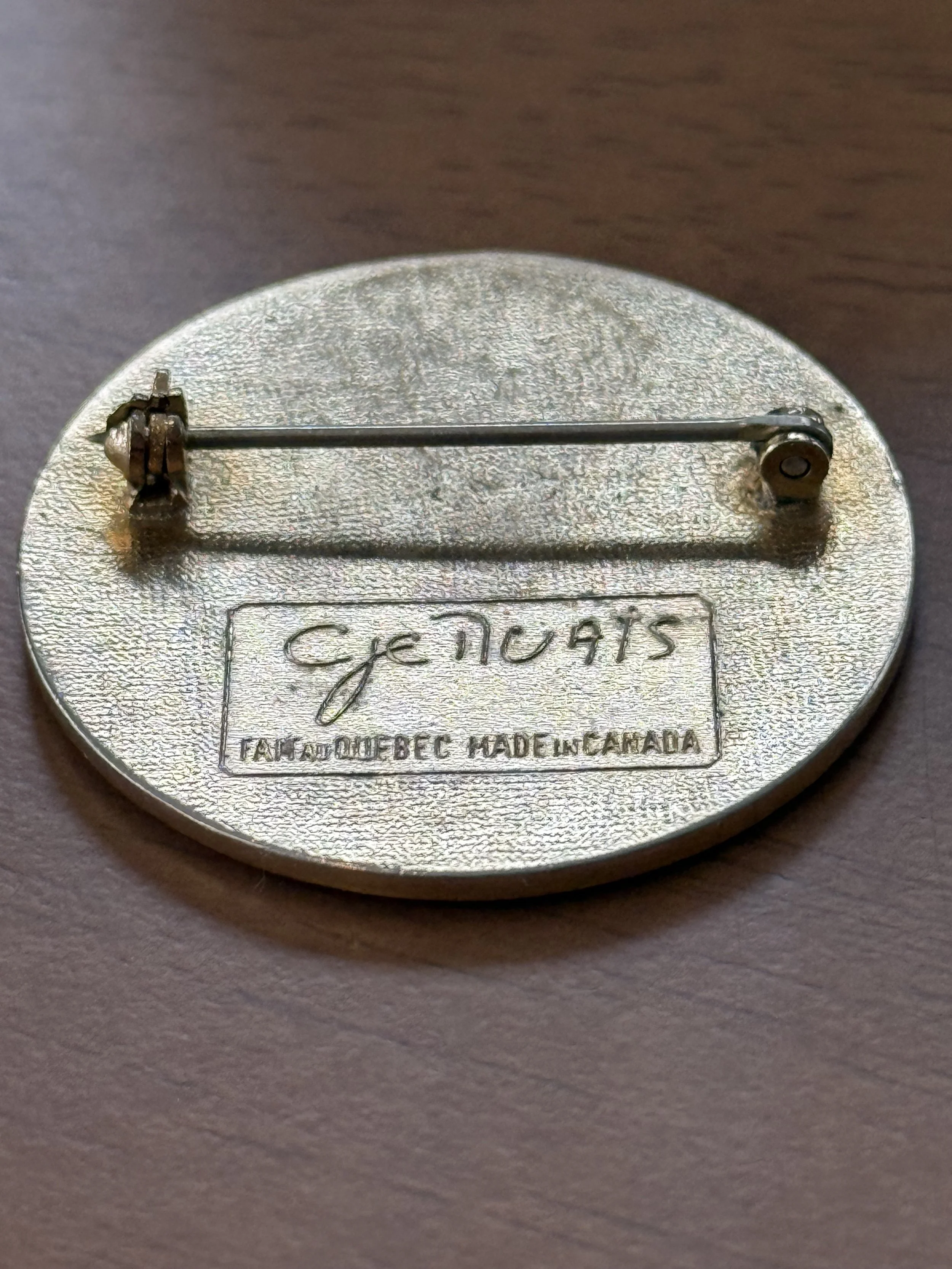 Back of vintage brass brooch with pin clasp and engraved maker mark, Canadian modernist jewelry, textured metal surface