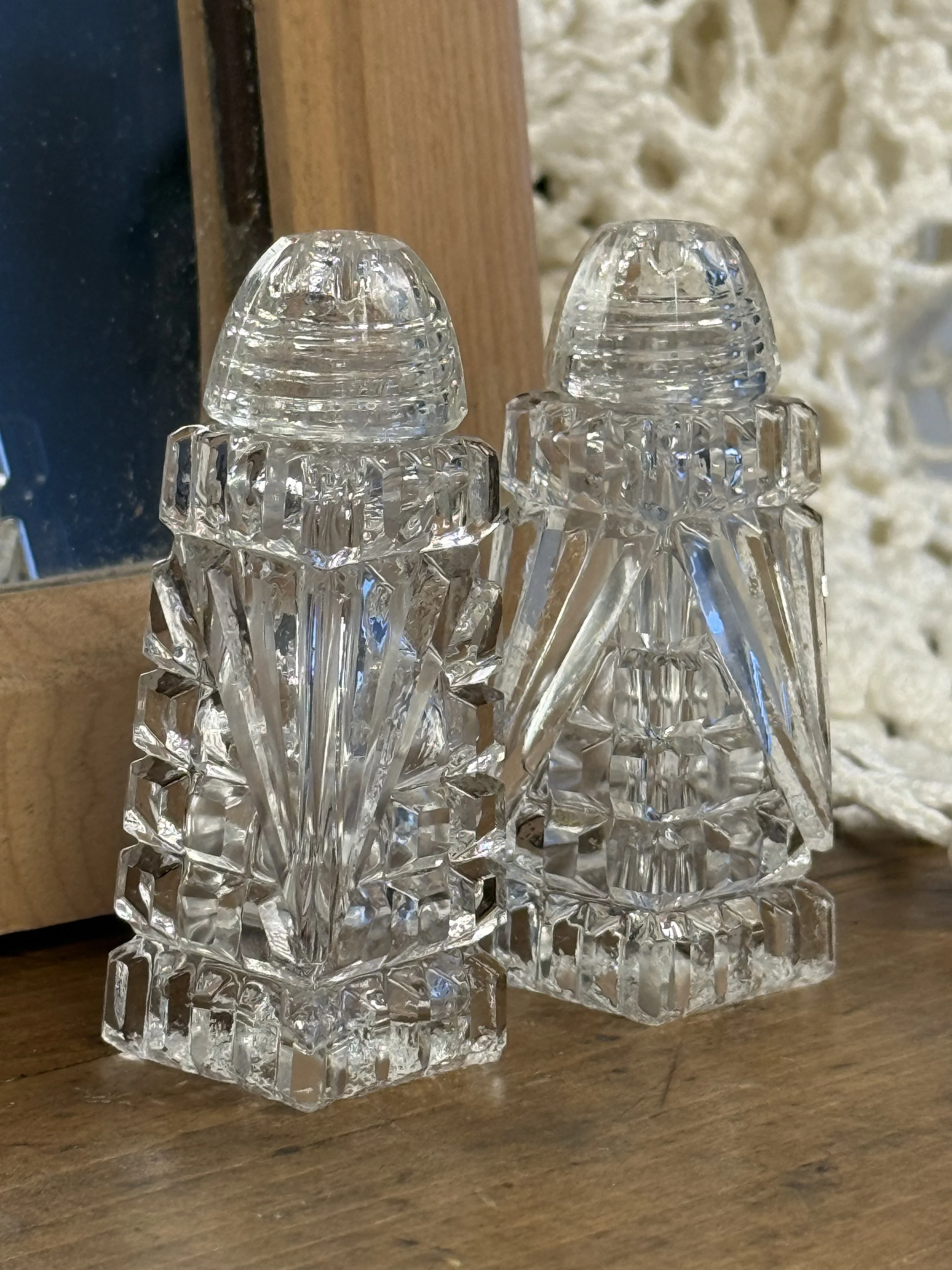 Vintage pressed glass salt and pepper shakers with stepped square bases, faceted sides and ribbed caps, mid-century clear glass table decor