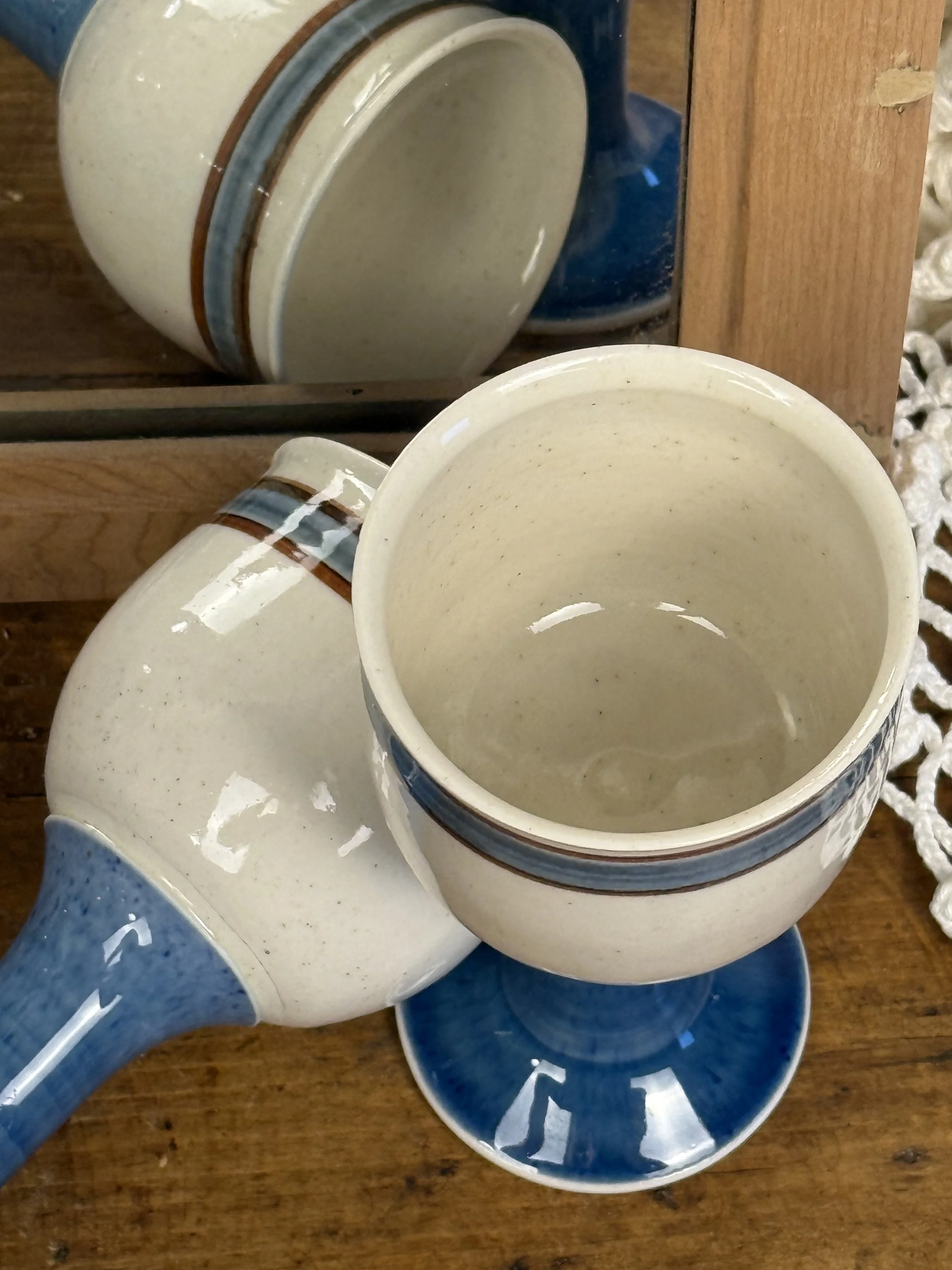 Top view vintage ceramic goblets, cream stoneware cups with blue band detail, handmade studio pottery drinkware