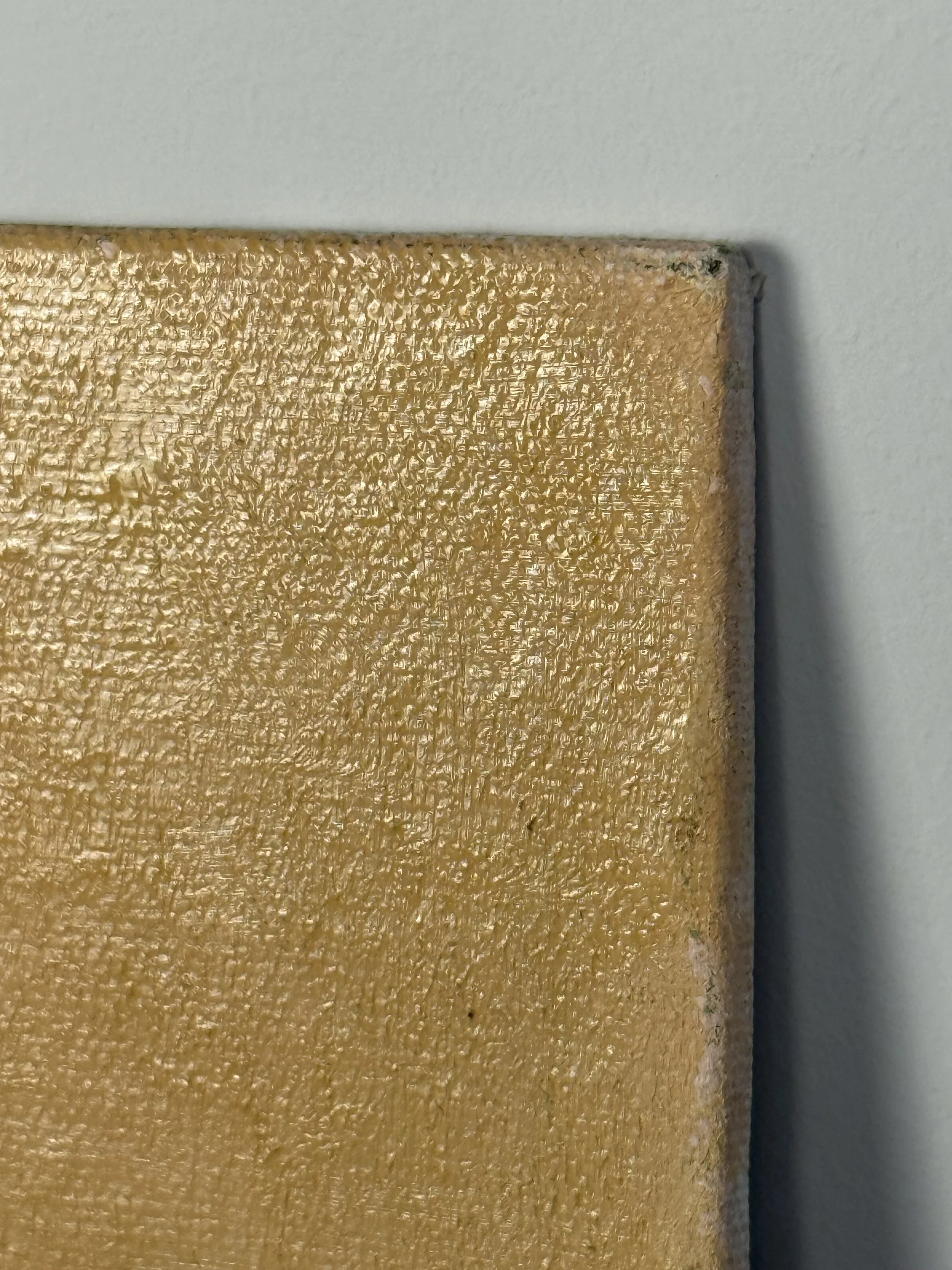 Edge detail of the 1996 oil on canvas board by J.J. Martel showing texture of the painted ochre background surface