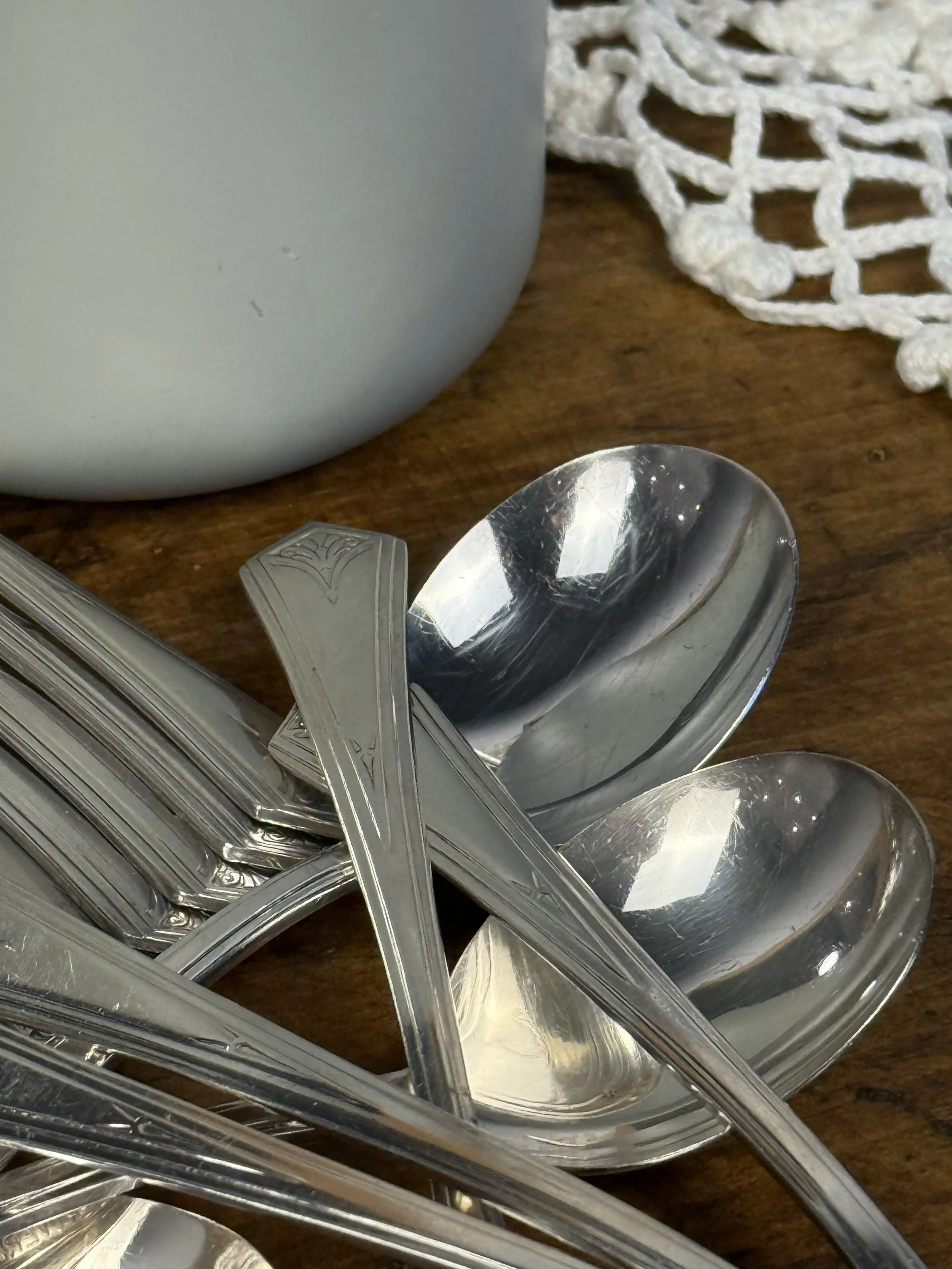 WM A Rogers vintage silver-plated spoons and forks close-up, geometric Art Deco handle detailing