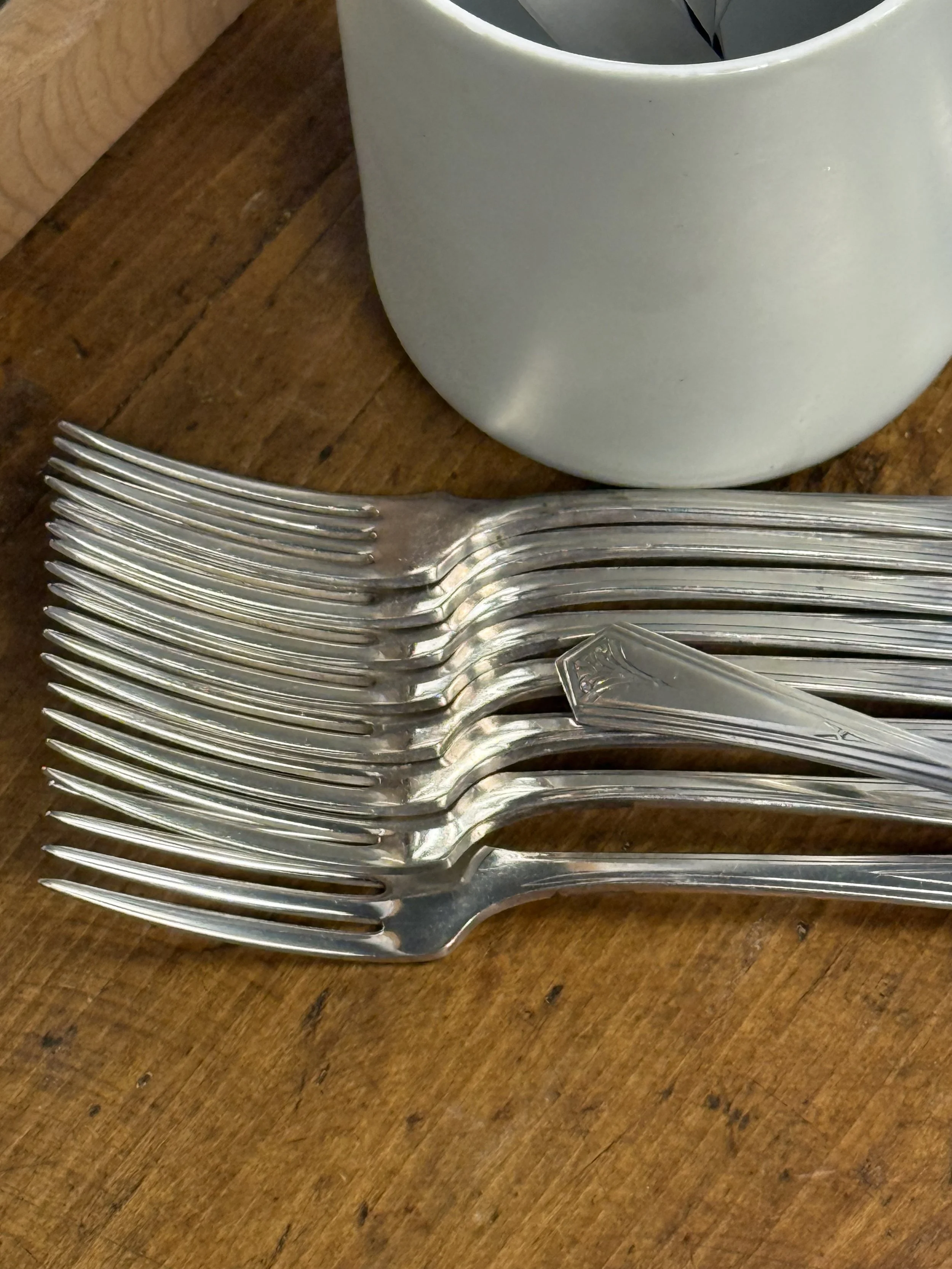 Vintage WM A Rogers silver-plated dinner forks stacked, stainless steel tines detail