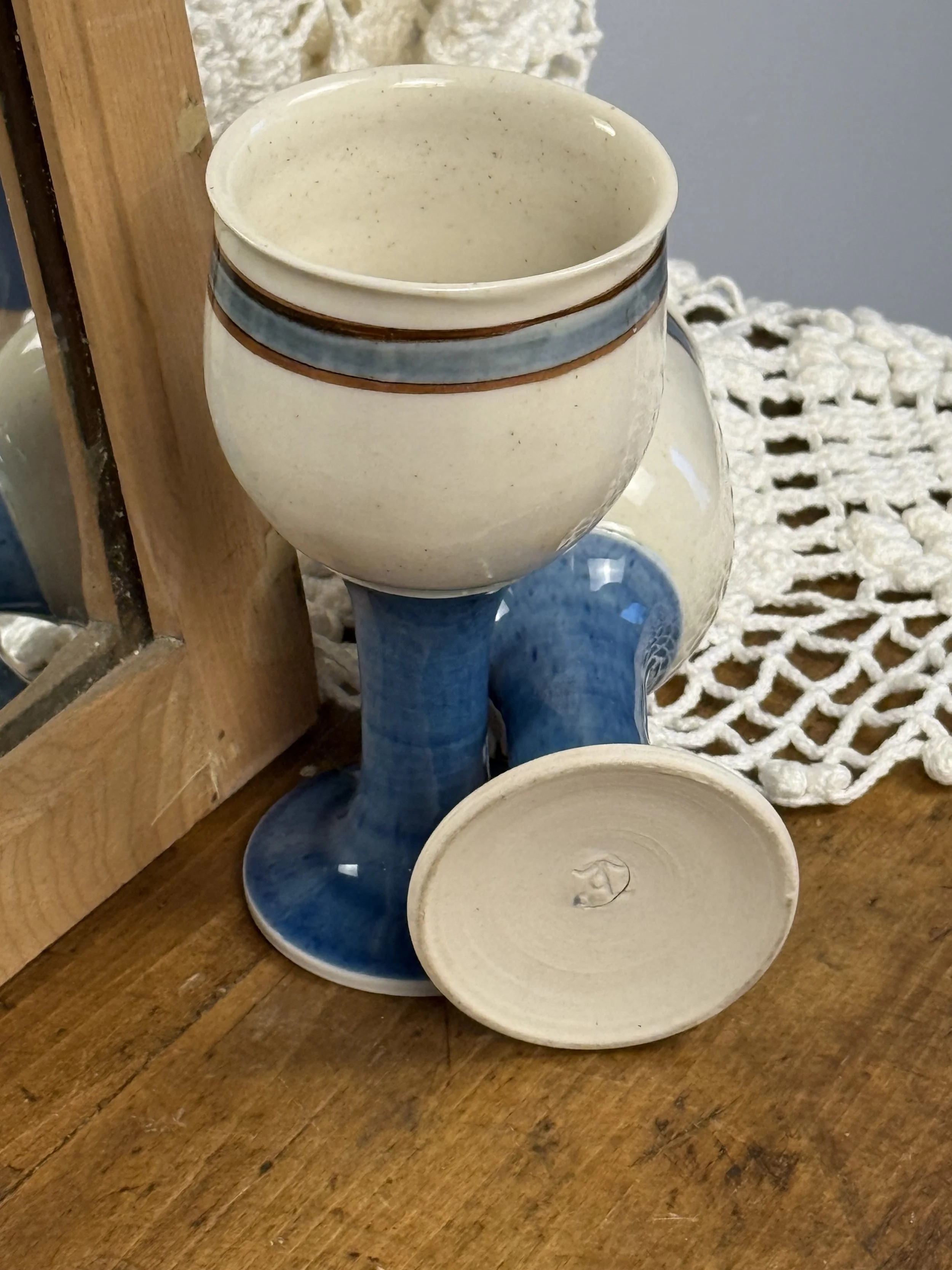 Vintage stoneware goblet interior, cream speckled glaze with blue and brown banding, handmade ceramic cup