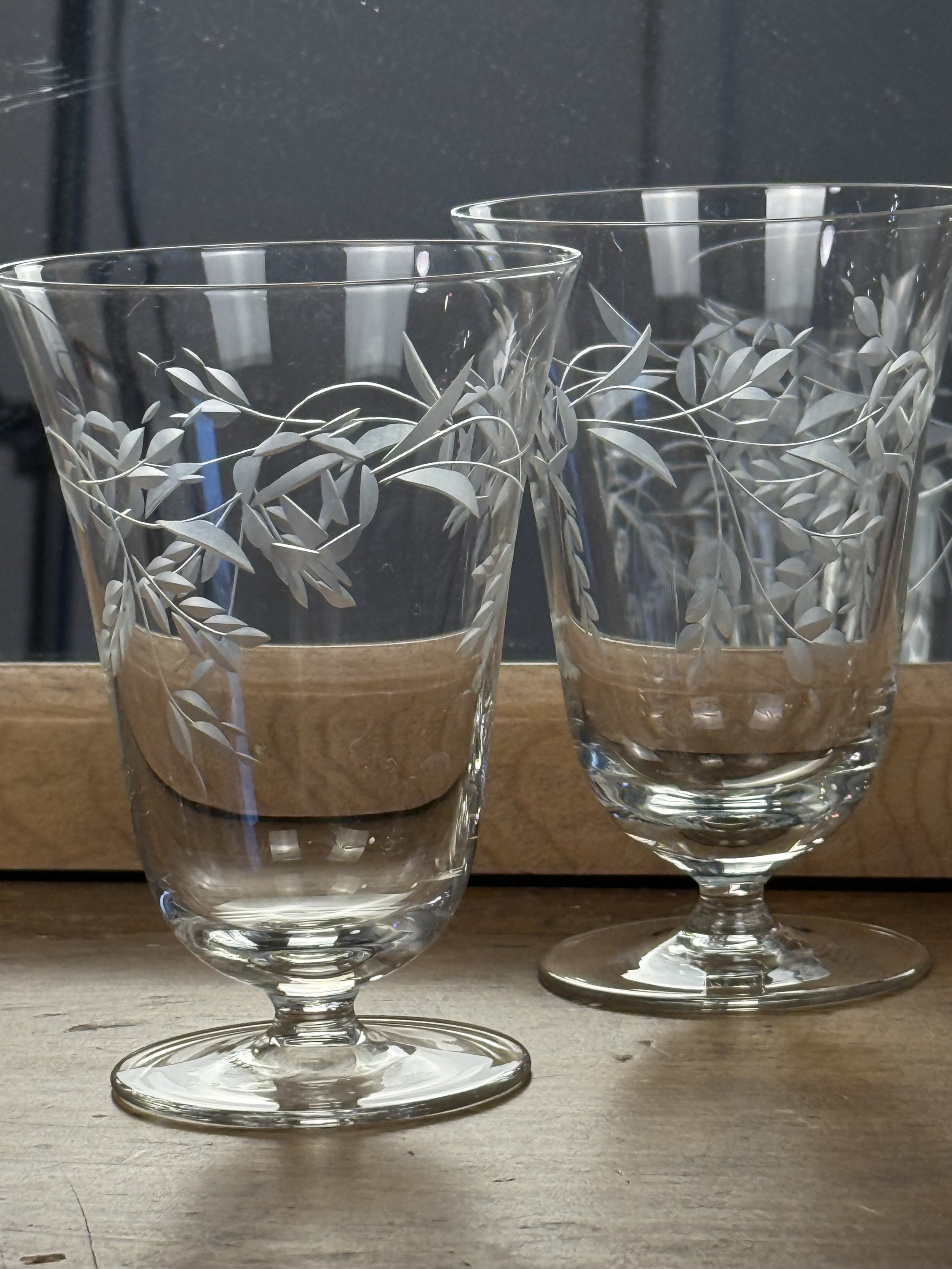 Vintage floral etched cocktail glasses set of four arranged together, clear glass barware with delicate leaf engraving, timeless table and bar decor