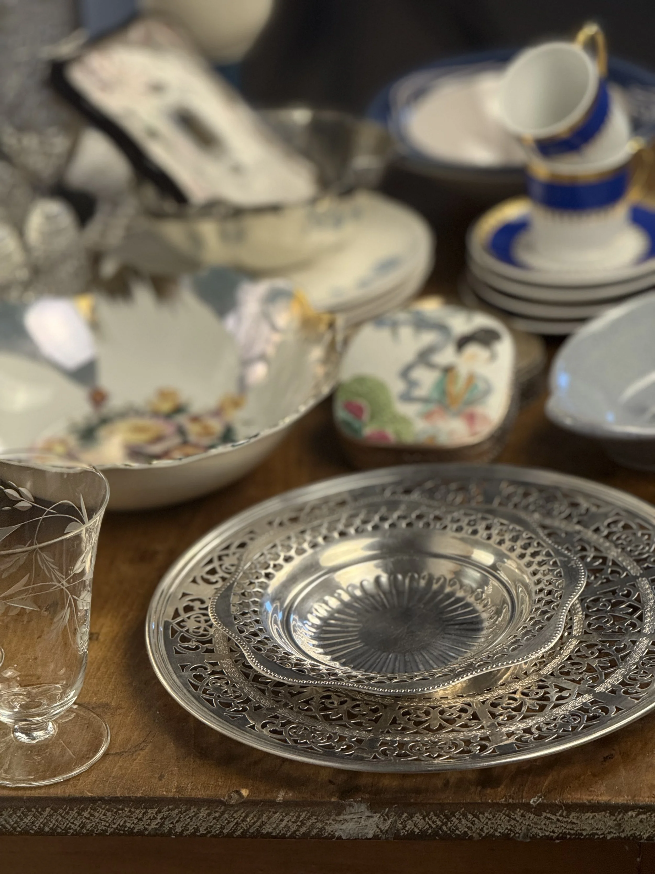 Vintage EP copper Viking plate silverplate serving dish with pierced scalloped rim, reflective bowl center, styled on wooden table with vintage porcelain and glassware