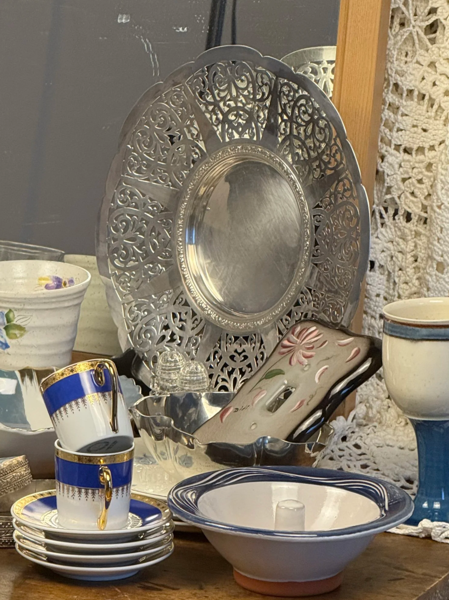 Styled tabletop scene featuring Birks pierced silverplate serving plate among vintage ceramics and glassware, elegant dining display inspiration