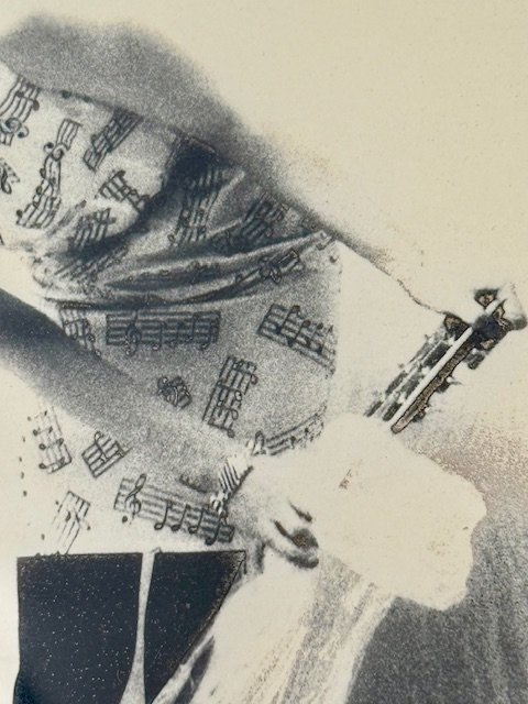 Close-up of abstract figure artwork showing textured grayscale brushwork and musical note motifs, expressive mid-century illustration with soft contrast