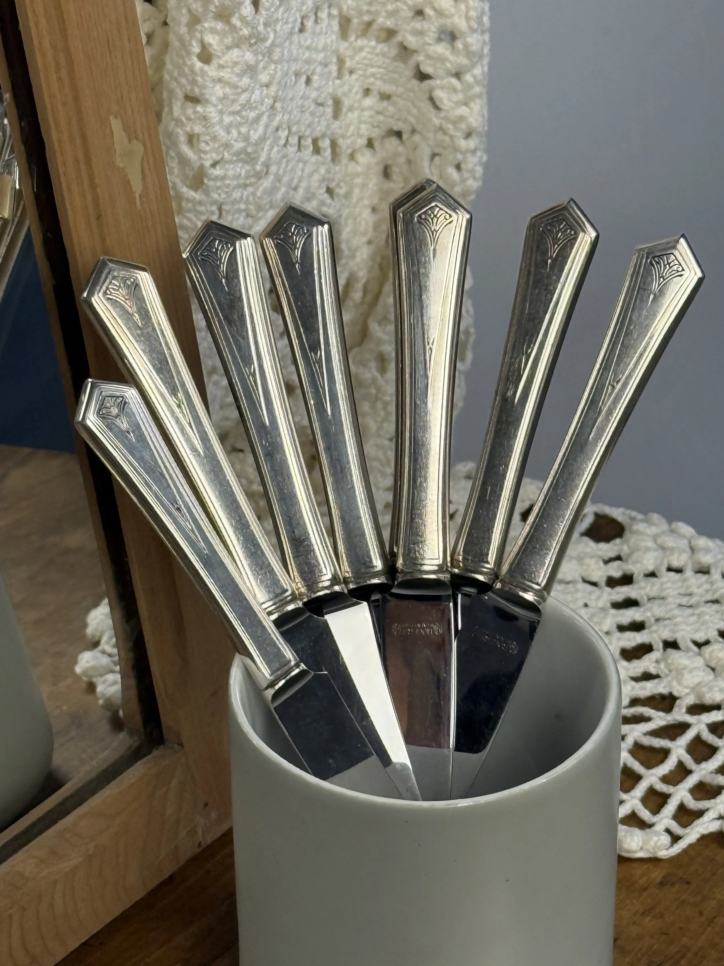 WM A Rogers Art Deco flatware handles detail, silver-plated geometric pattern close-up