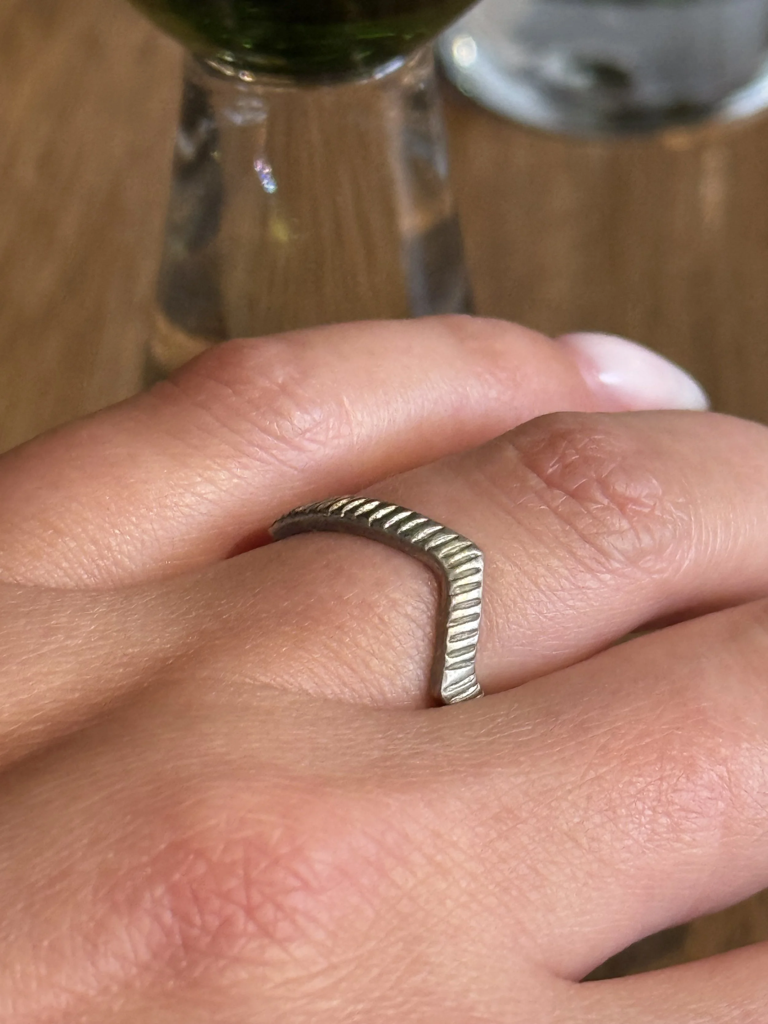 Vintage silver geometric open ring worn on hand, minimalist zigzag form with subtle patina and sculptural design