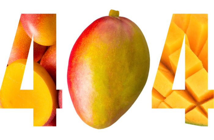 Whole mango fruit with some cut into slices and cubes around it.