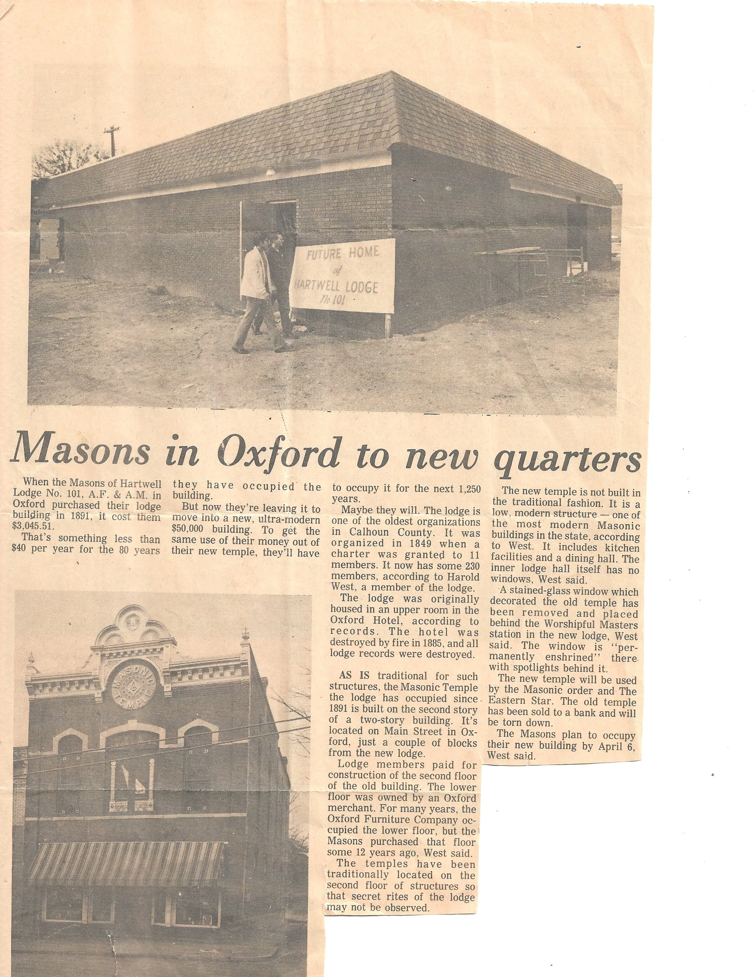 A black and white newspaper clipping showing a building under construction with a sign that reads "Future Home of Hartwell Lodge No. 101." The article title is "Masons in Oxford to new quarters," discussing the relocation of the Masonic Lodge in Oxfo