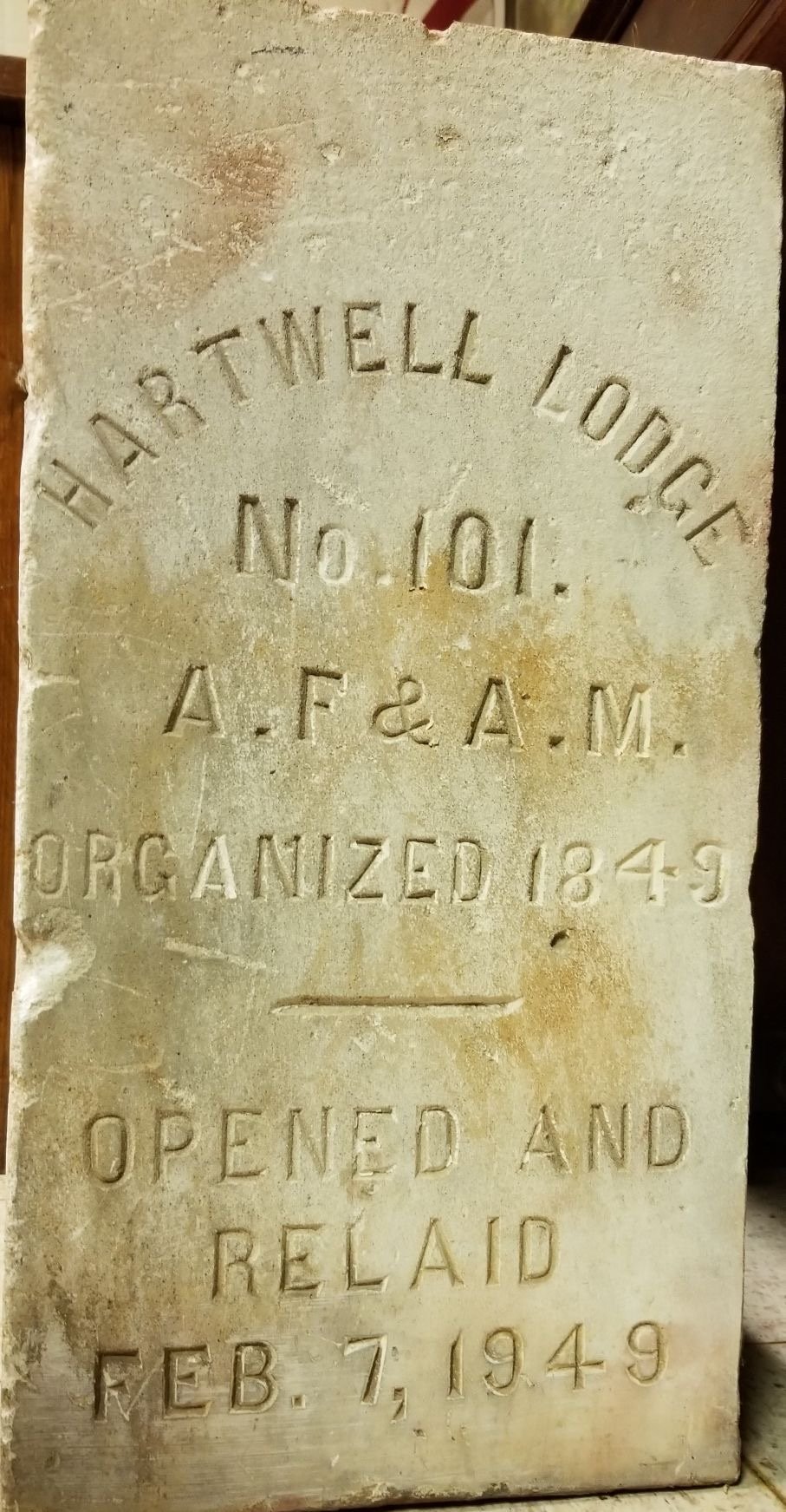 A historical engraved stone plaque with the text: Hartford Lodge No. 101, A.F. & A.M., organized 1849. Opened and read Feb. 7, 1949.