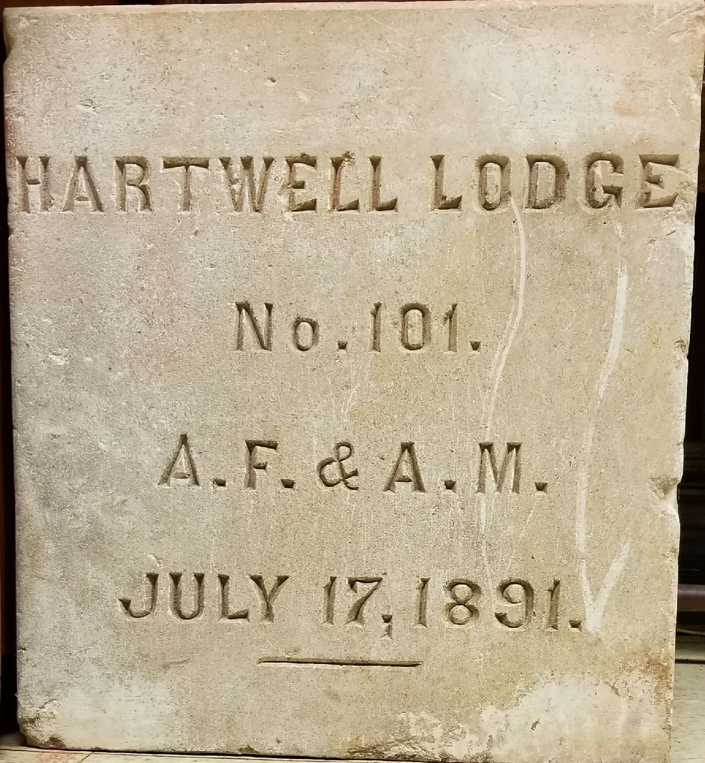 Stone plaque with engraved text reading 'Hartwell Lodge No. 101. A.F. & A.M. July 17, 1891.'