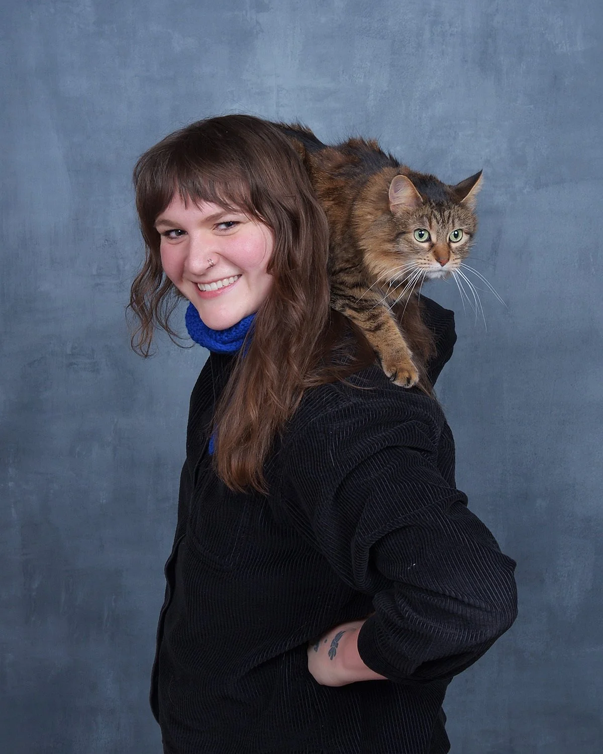 Women (Emily Steuer) with a cat on her shoulder.