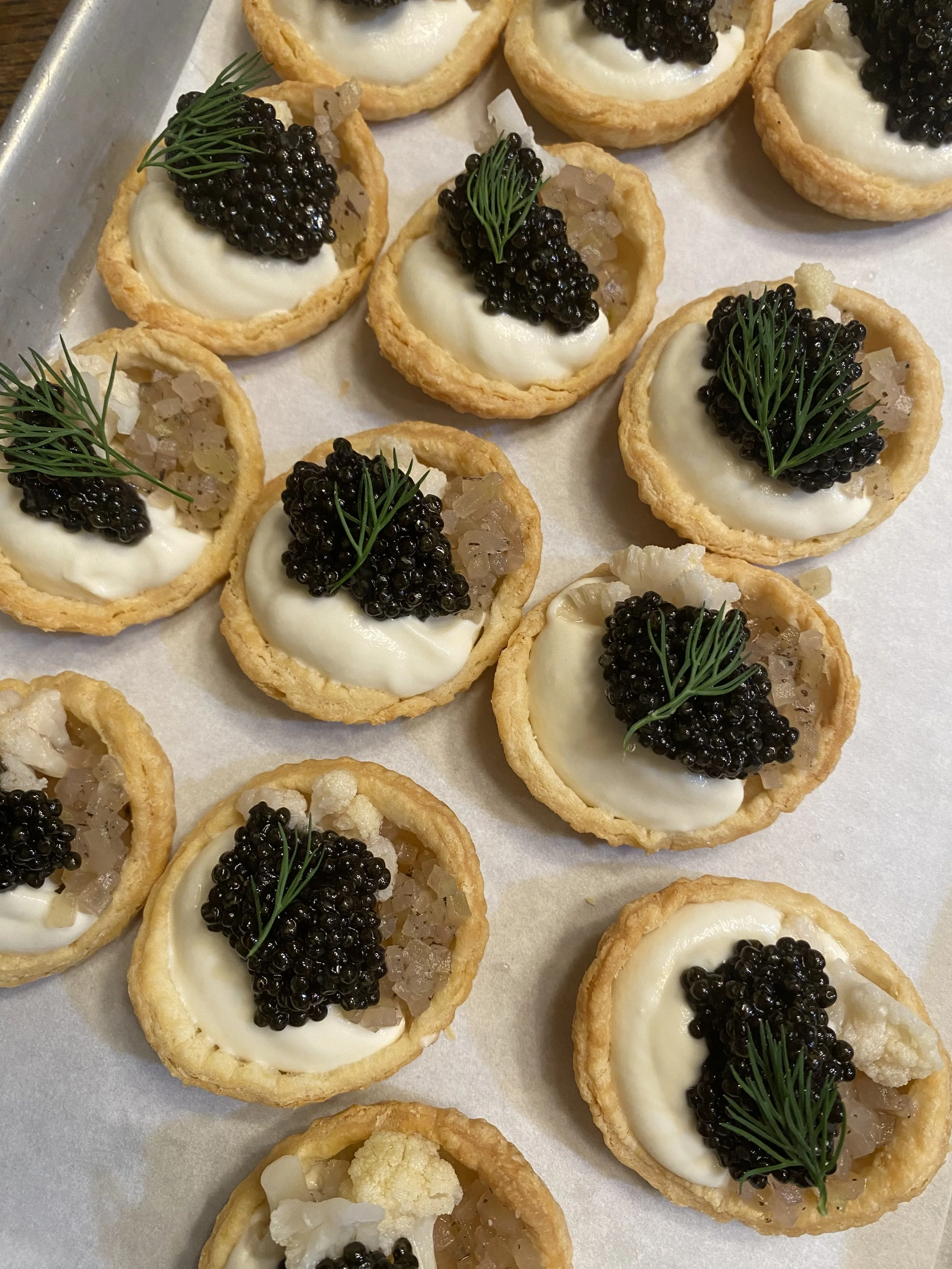 Mini tartlets with a cauliflower puree, topped with caviar and dill.
