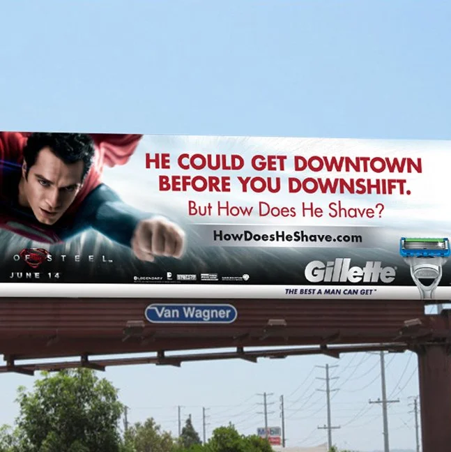 Gillette entertainment marketing billboard with Superman promoting the “How Does He Shave?” campaign, driving fans to HowDoesHeShave.com.
