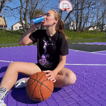 X2 Energy organic social ad for sports drink campaign featuring female fitness influencer practicing basketball on an outdoor court with headline “More Bounce Per Ounce” after drinking X2.