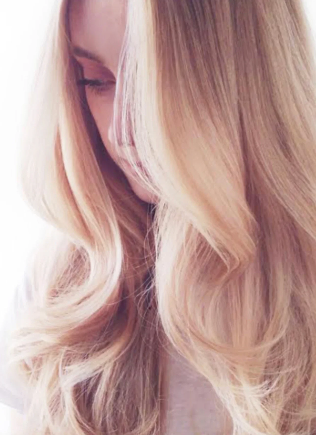 Close-up of a woman with long, wavy blonde hair.