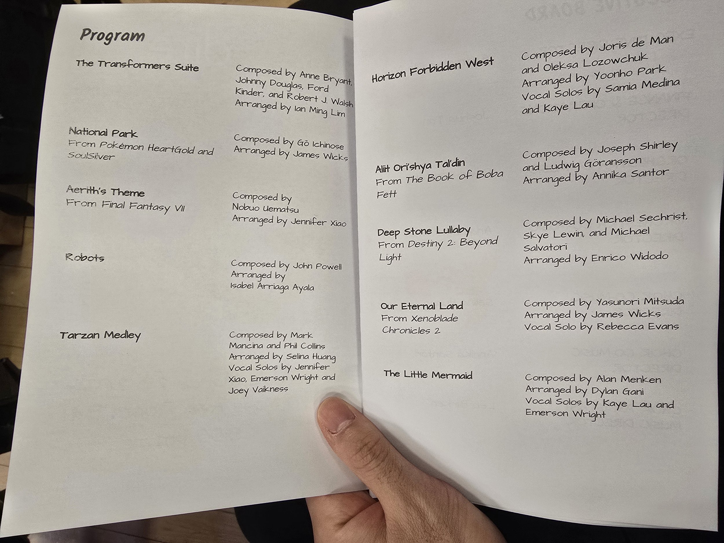 Open booklet showing list of musical compositions with titles, composers, and arrangers.