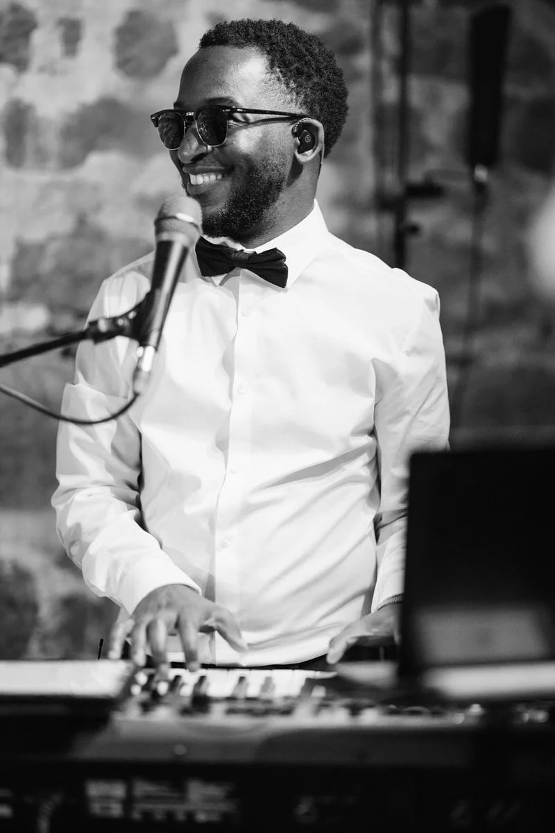 Keyboard player performing with wedding band at Tithe Barn Symondsbury Dorset during live barn wedding entertainment