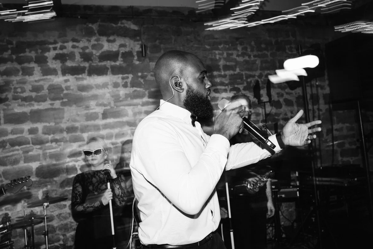 Male singer performing with wedding band at Tithe Barn Symondsbury Dorset during live barn wedding entertainment