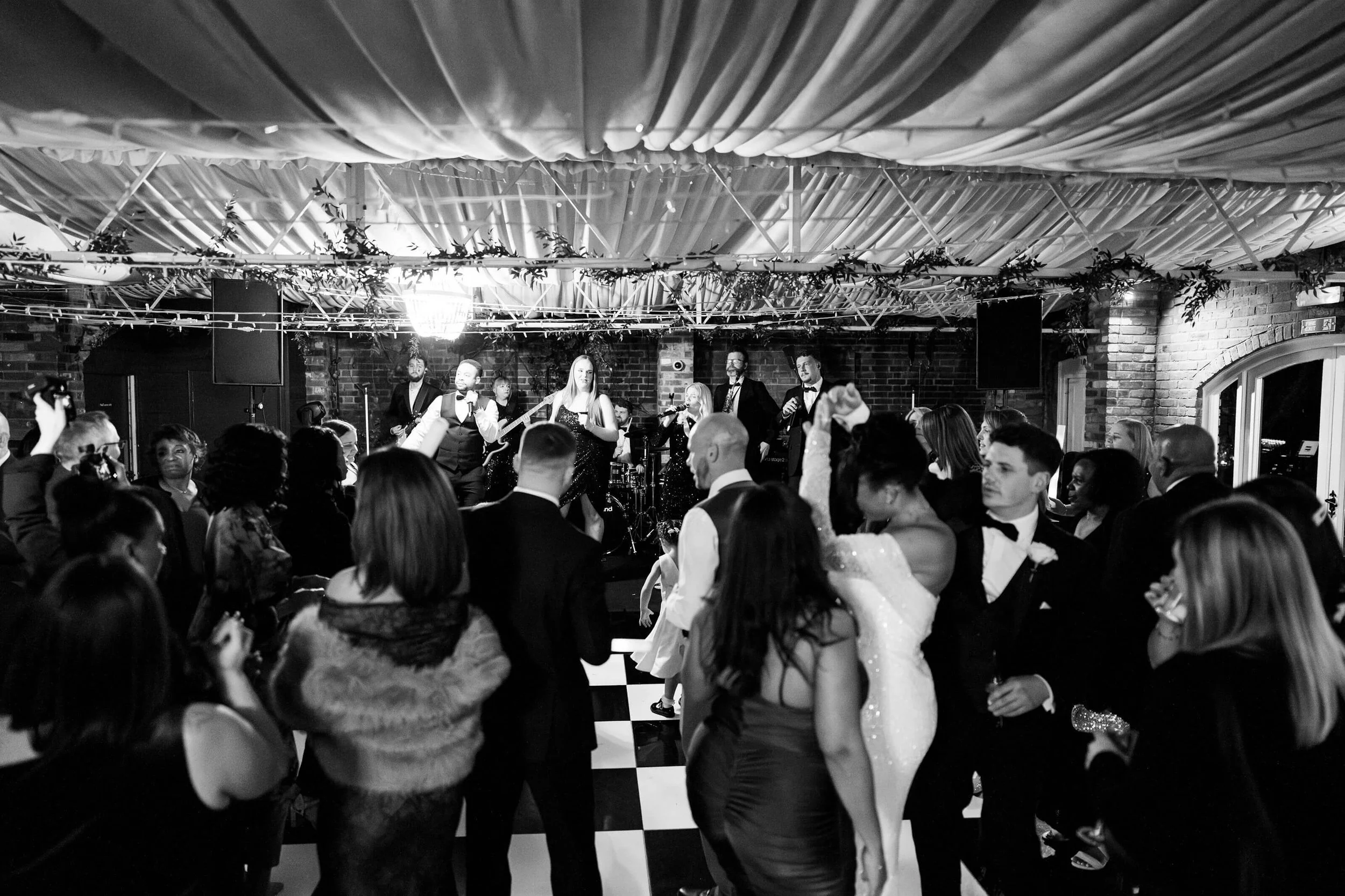 NeoRoots band performing to a packed dance floor