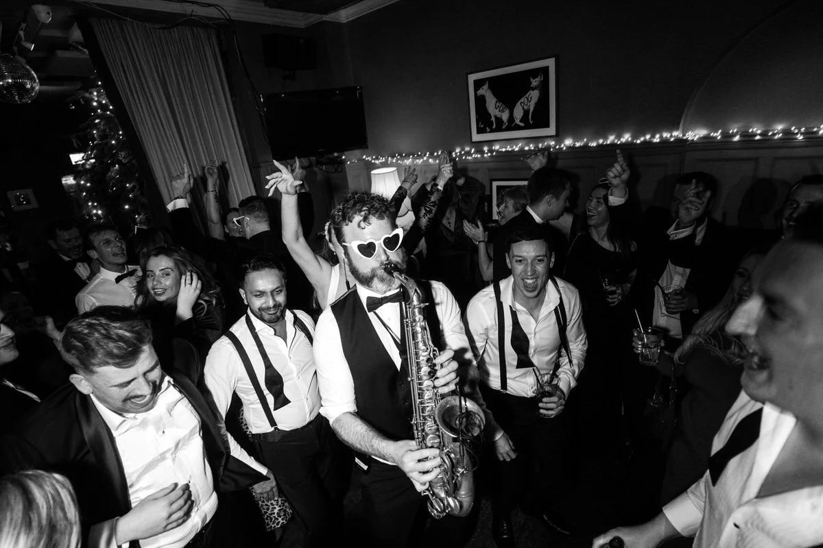Guests dancing with the NeoRoots saxophonist during a New Year’s Eve wedding reception in London.