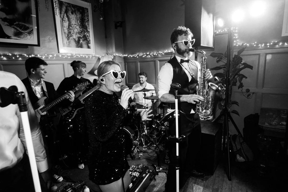 NeoRoots wedding band performing for guests during a lively London wedding celebration at The Larrik.