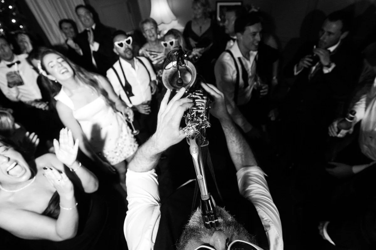 NeoRoots saxophonist performing in the middle of a packed wedding dancefloor during a London New Year’s Eve celebration.