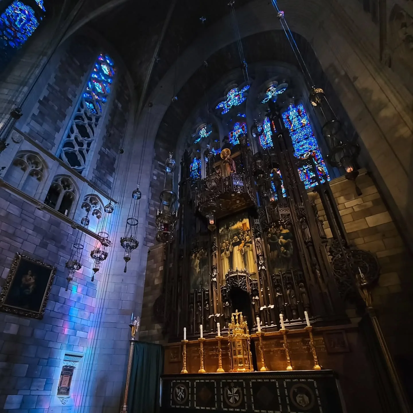 Afternoon light seeps through the stained-glass windows, casting beautiful glows around the High Altar and Cloister Walk at St. Vincent's.