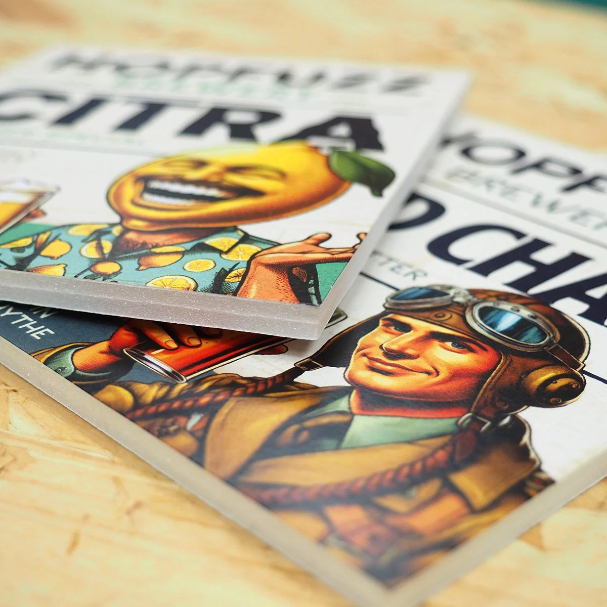 Close-up of comic book covers featuring vintage-style characters, one with a smiling pilot wearing goggles and another with a lemon-headed character holding a drink.