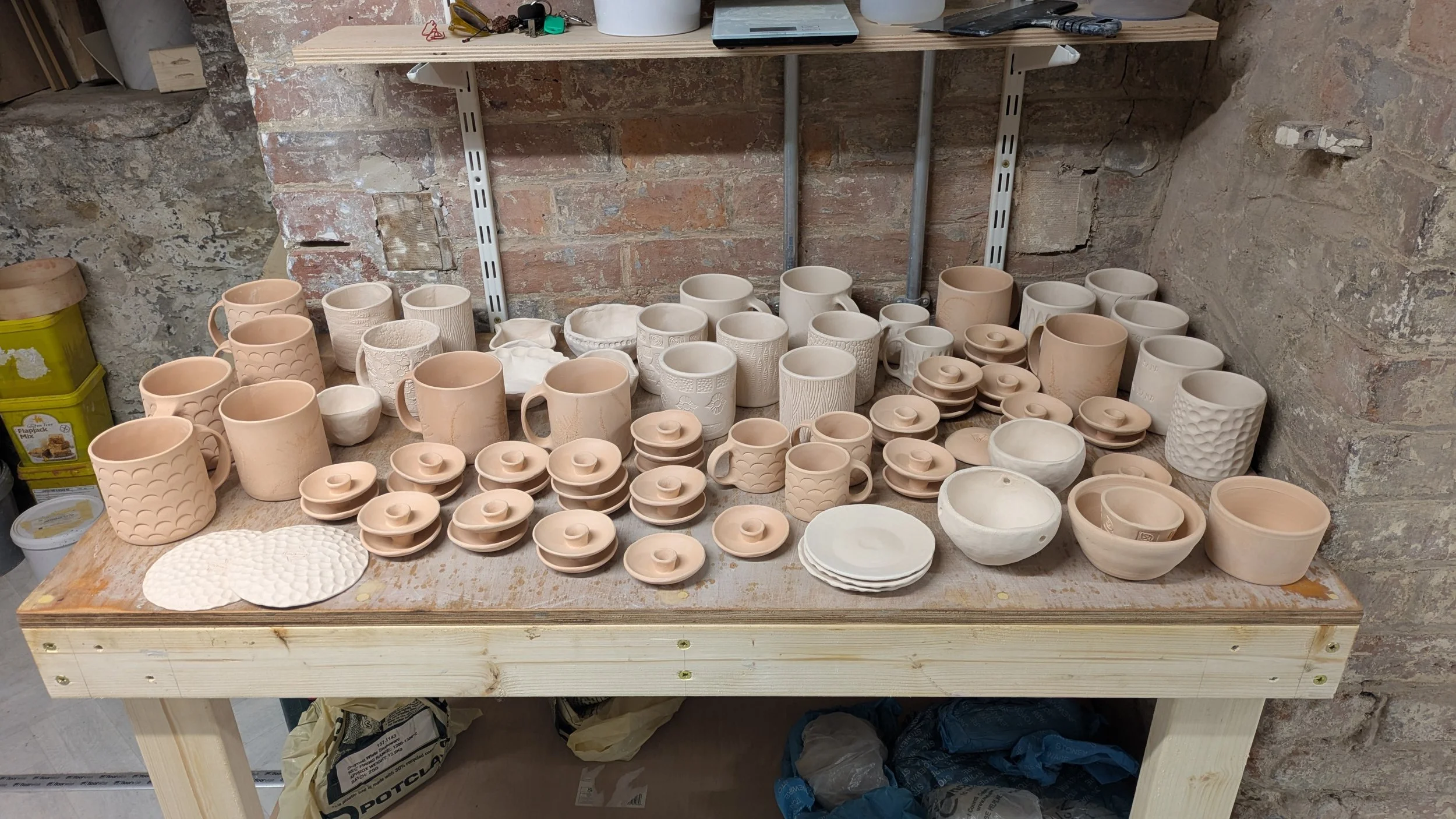 Bisque fired ceramics waiting to be glazed and fired again.