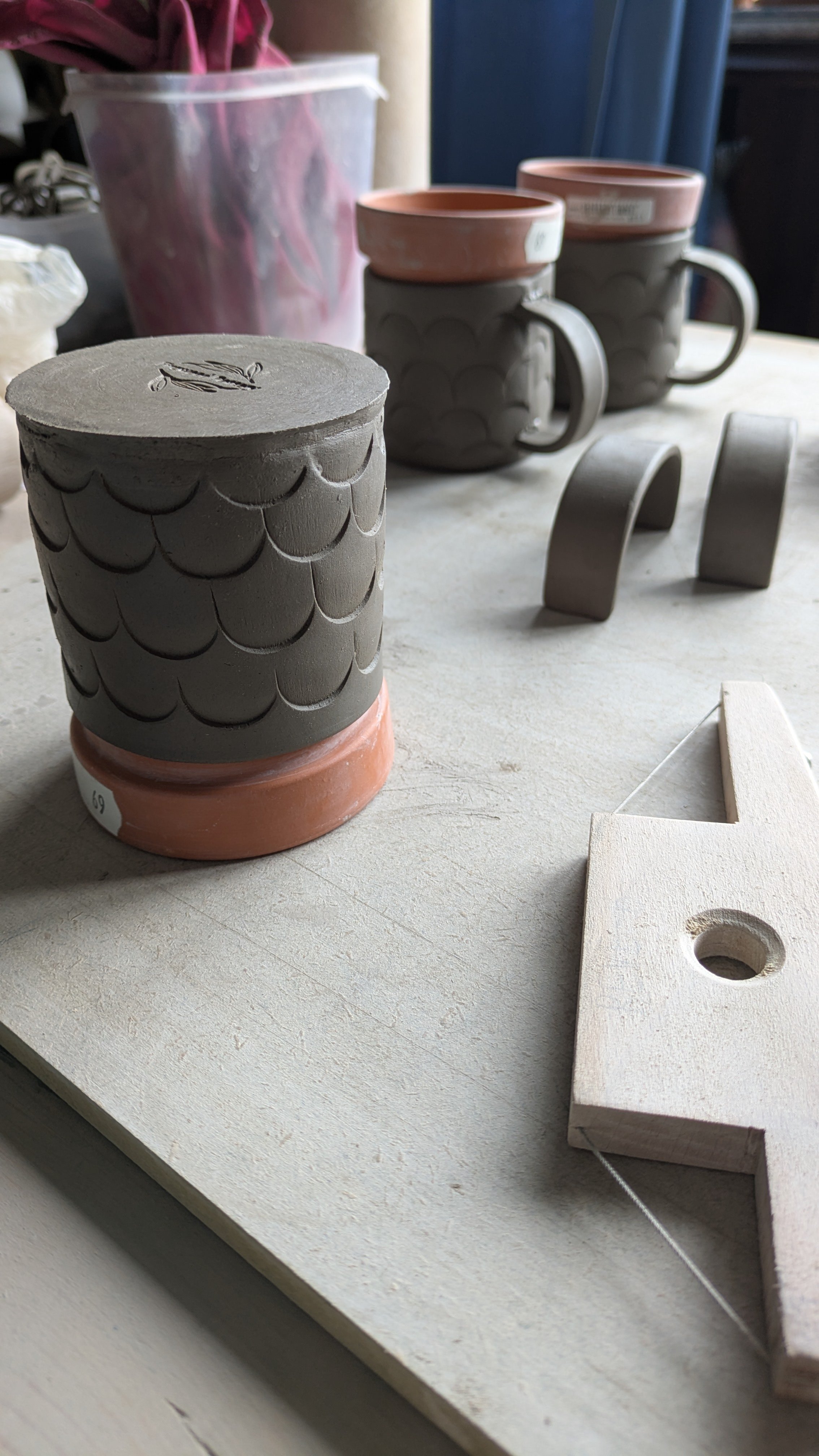 Three small slab built mugs in progress. Attaching handles.