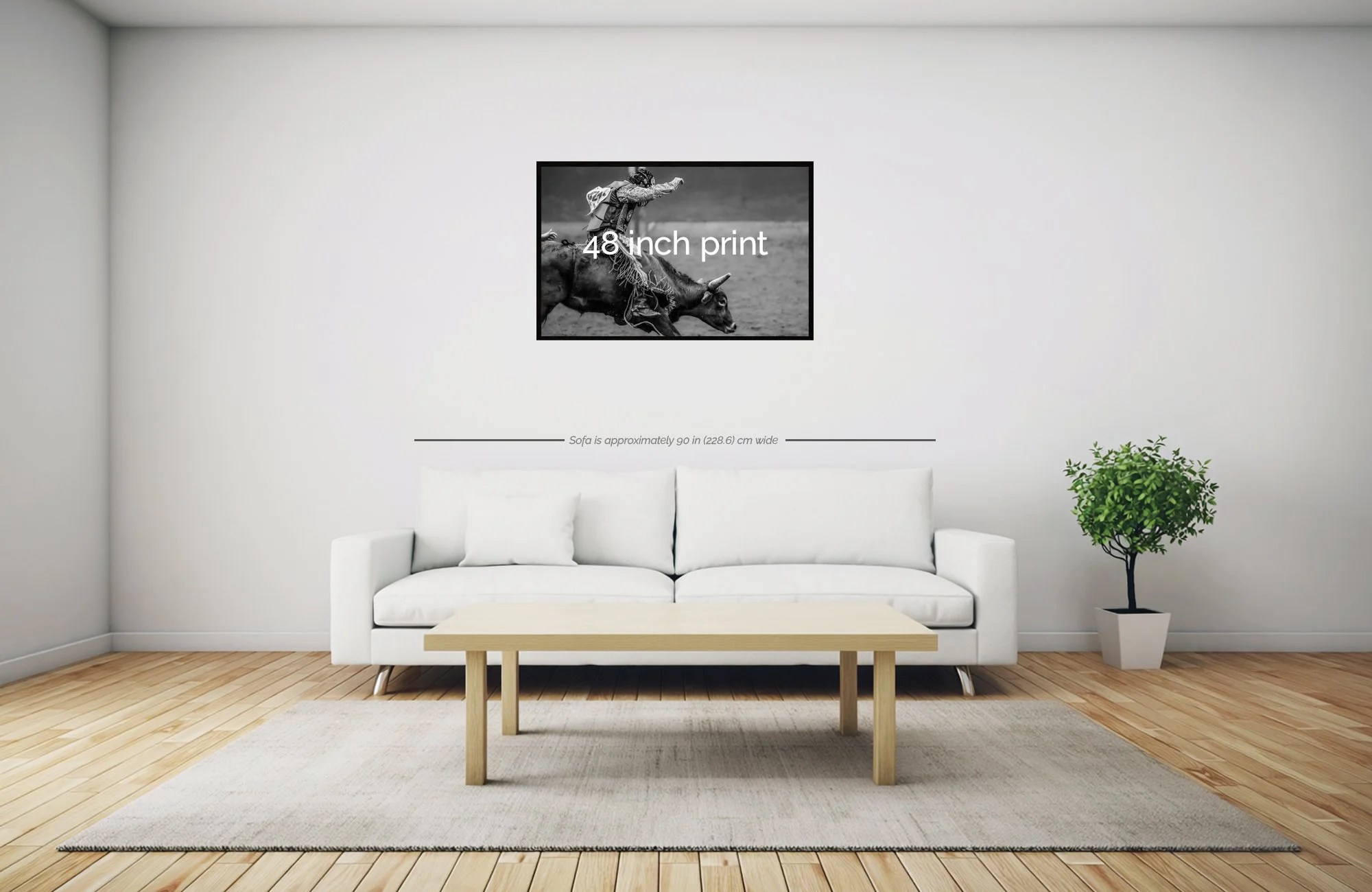 Living room with white couch, wooden coffee table, potted plant, and wall art measuring 48 inches in width