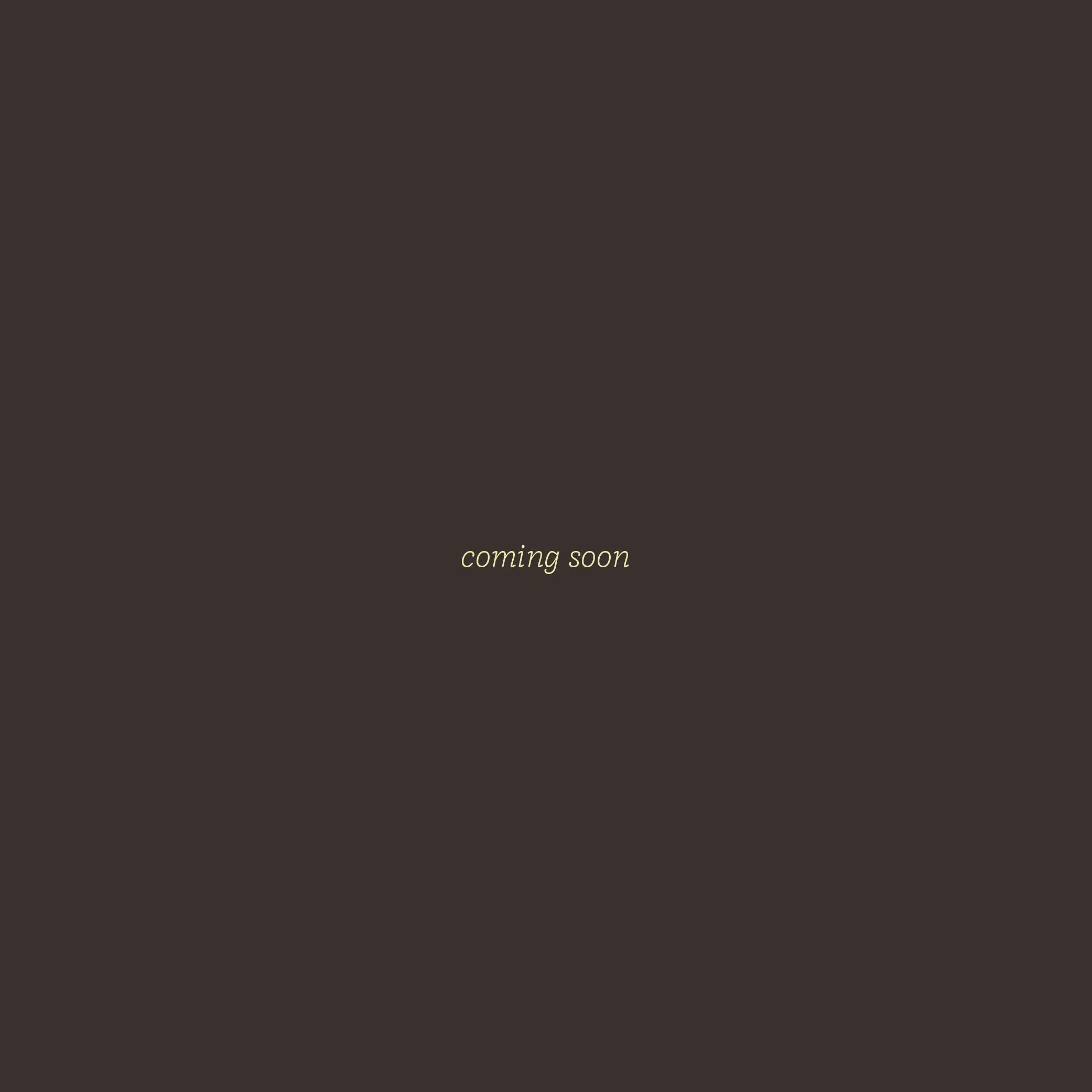 A dark background with the words 'coming soon' centered in light yellow text.