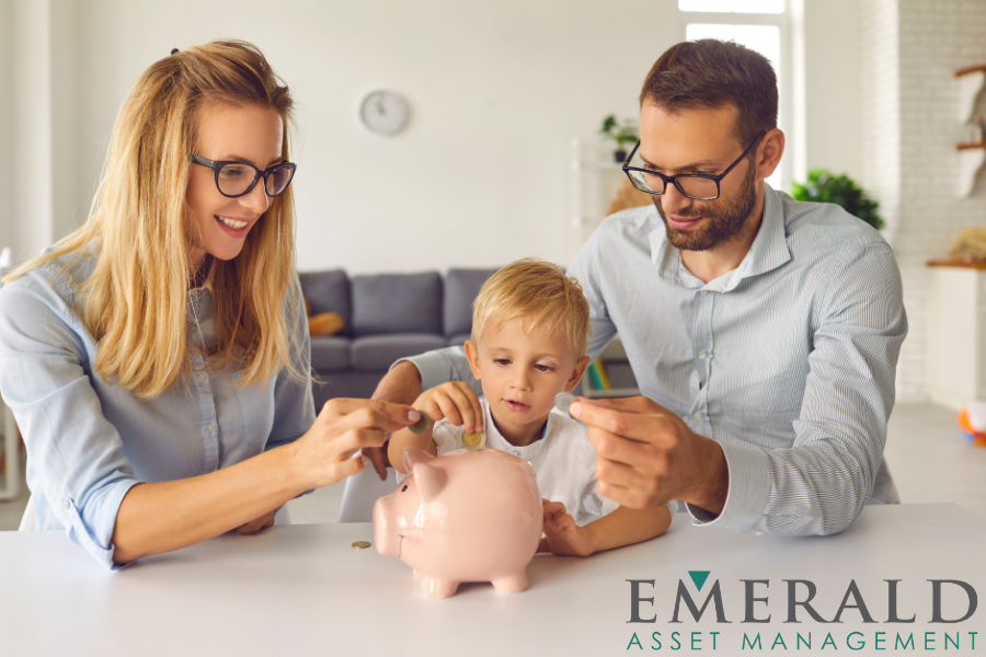 man, woman and child dropping coins into a piggy bank